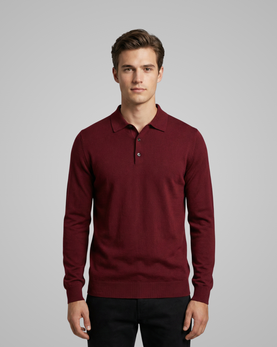 Man wearing a burgundy long-sleeve polo shirt against a gray background