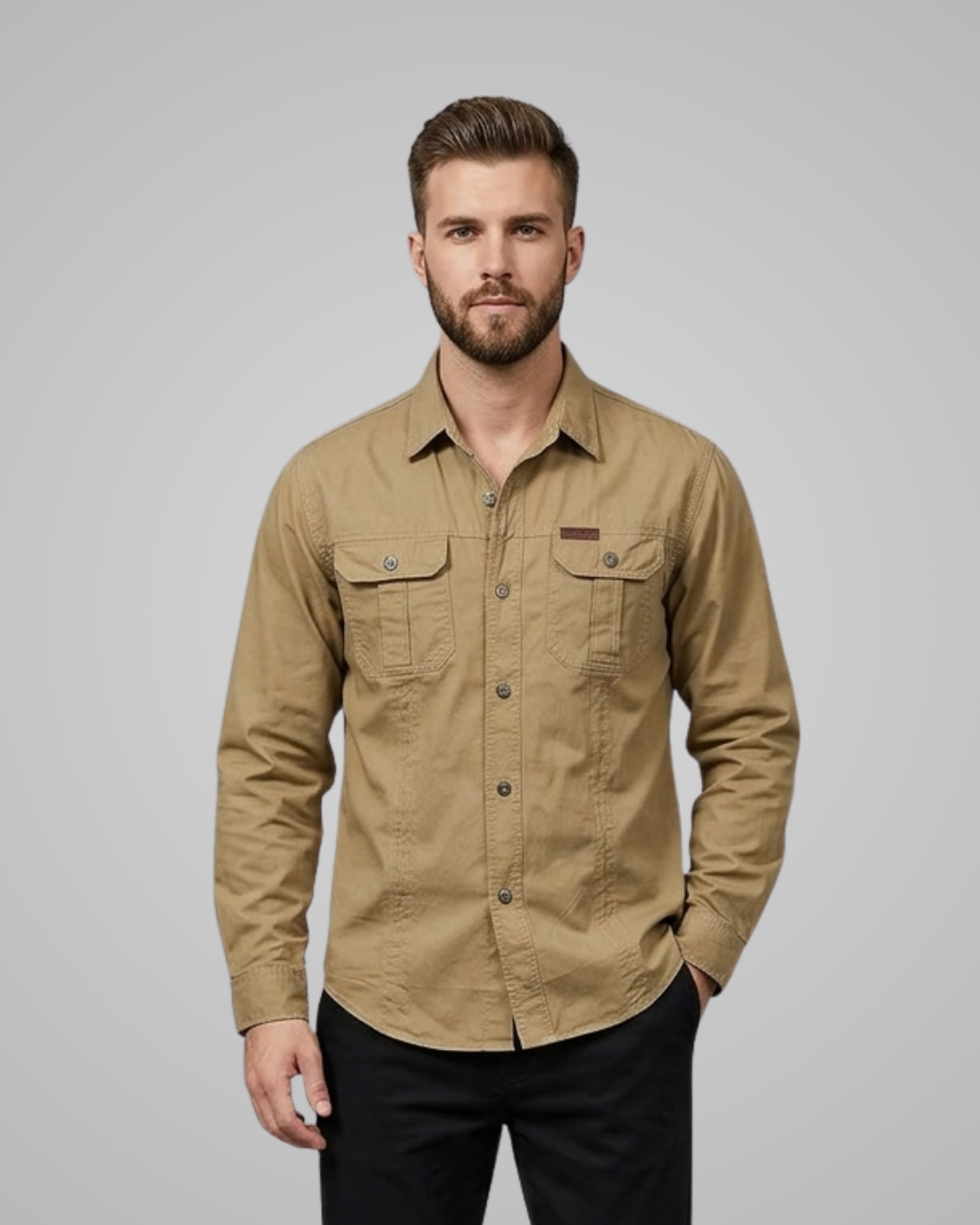 Man wearing a beige shirt against a gray background