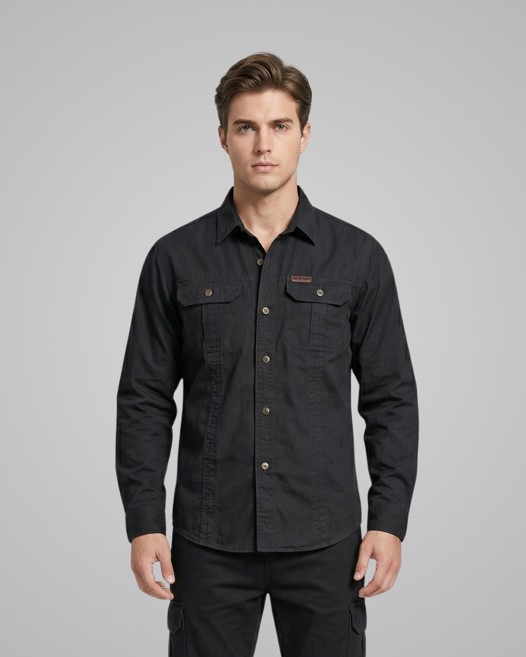 Man wearing a black shirt with a gray background