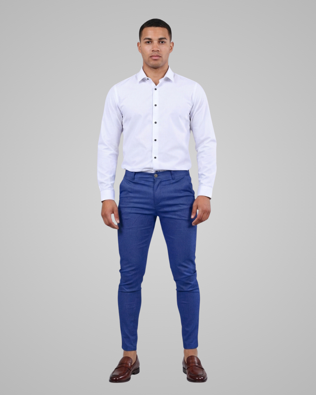 Man wearing a white shirt and blue pants on a gray background