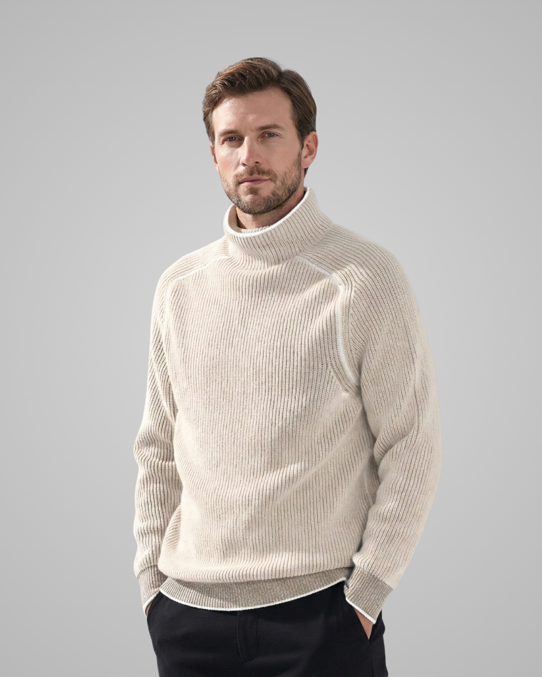 Man wearing a beige turtleneck sweater against a gray background