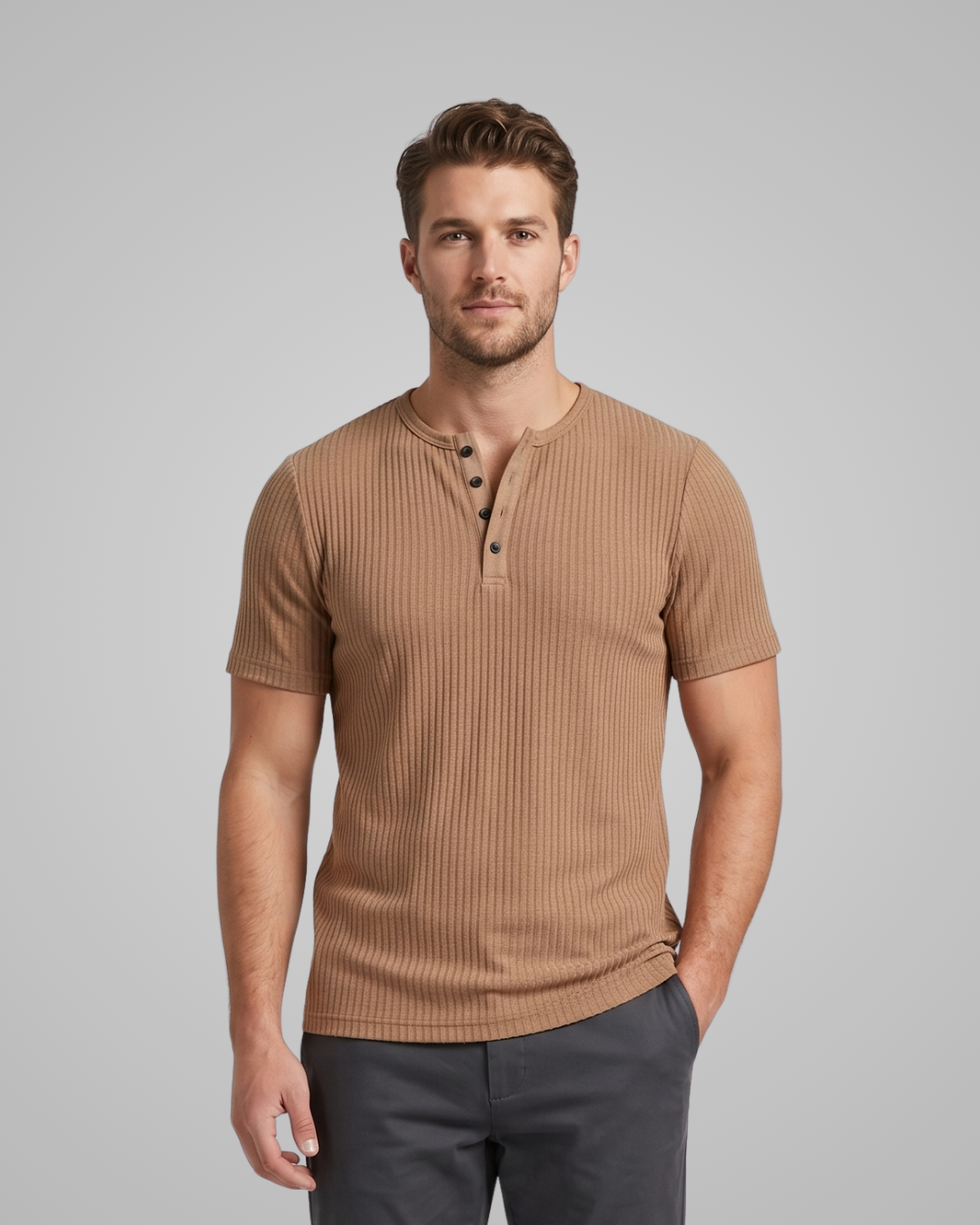 Man wearing a brown ribbed henley shirt against a gray background