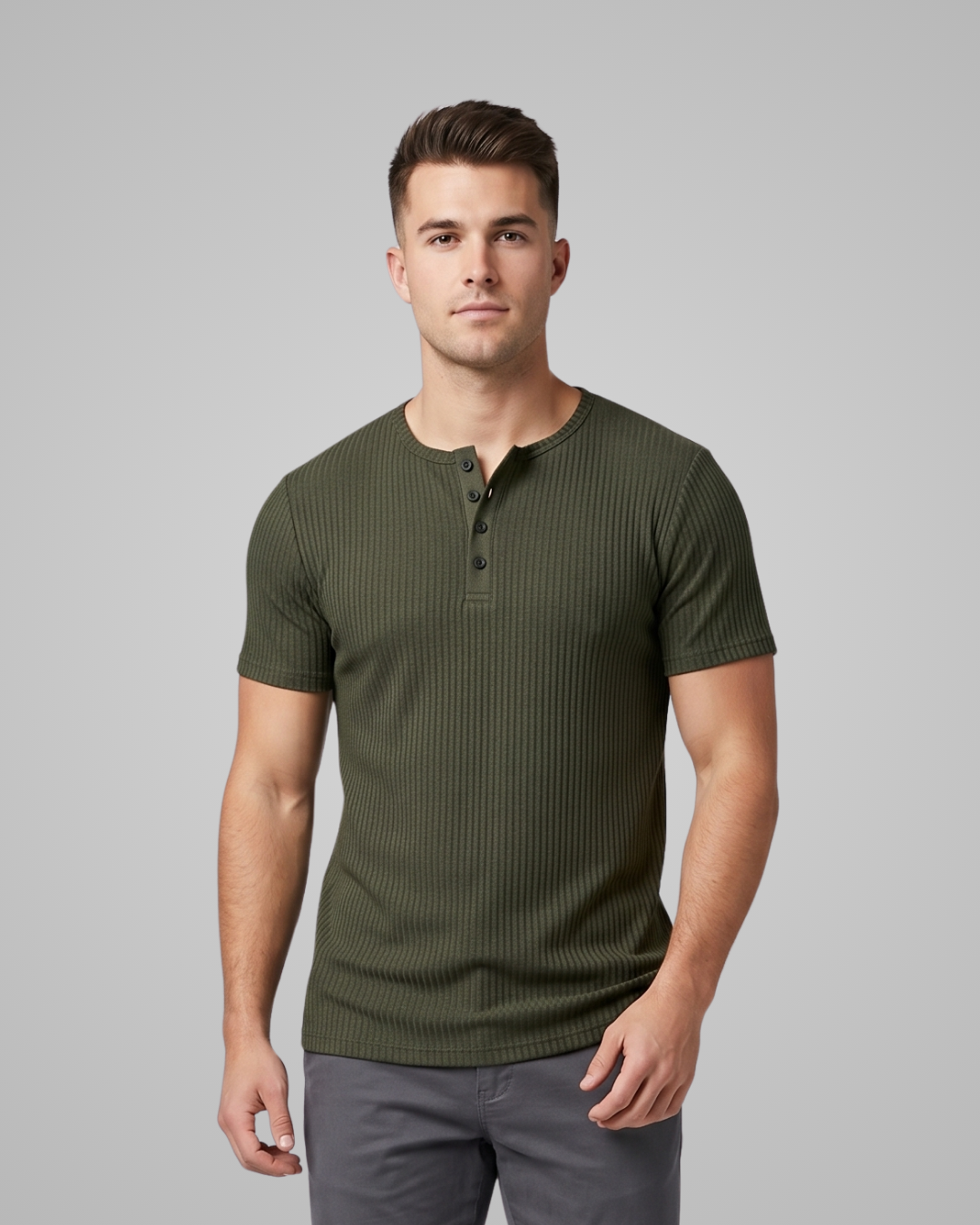 Man wearing a green henley shirt against a gray background
