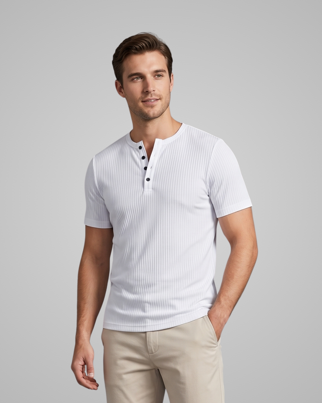 Man wearing a white ribbed henley shirt and beige pants on a gray background