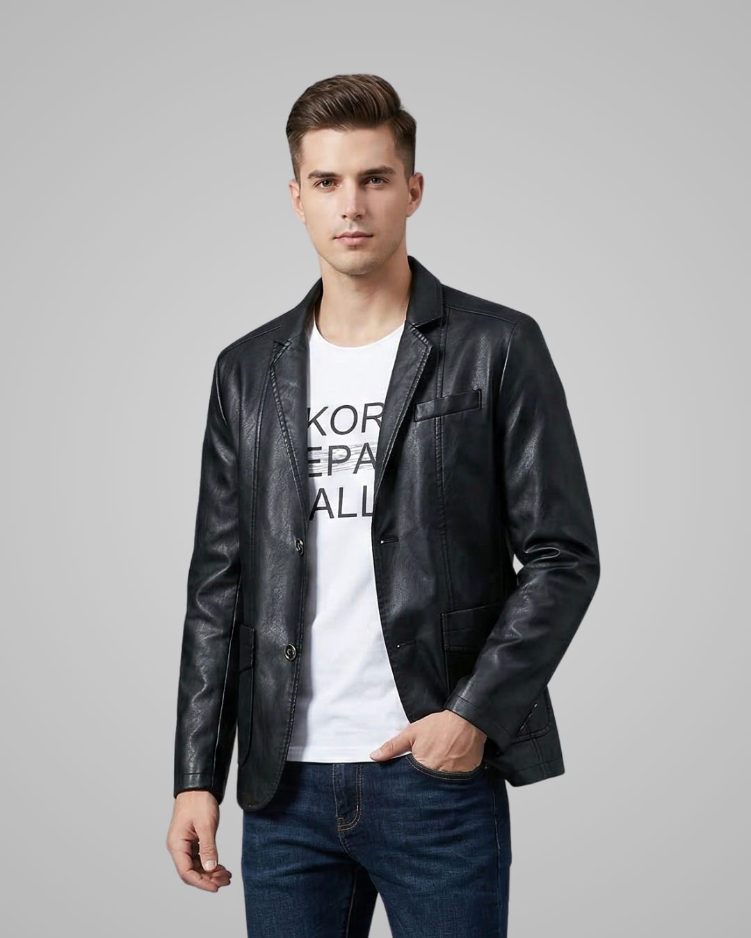 Man wearing a black leather jacket over a white t-shirt with text on a gray background