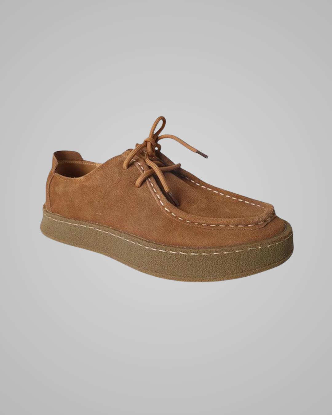 Brown suede shoe on a gray background