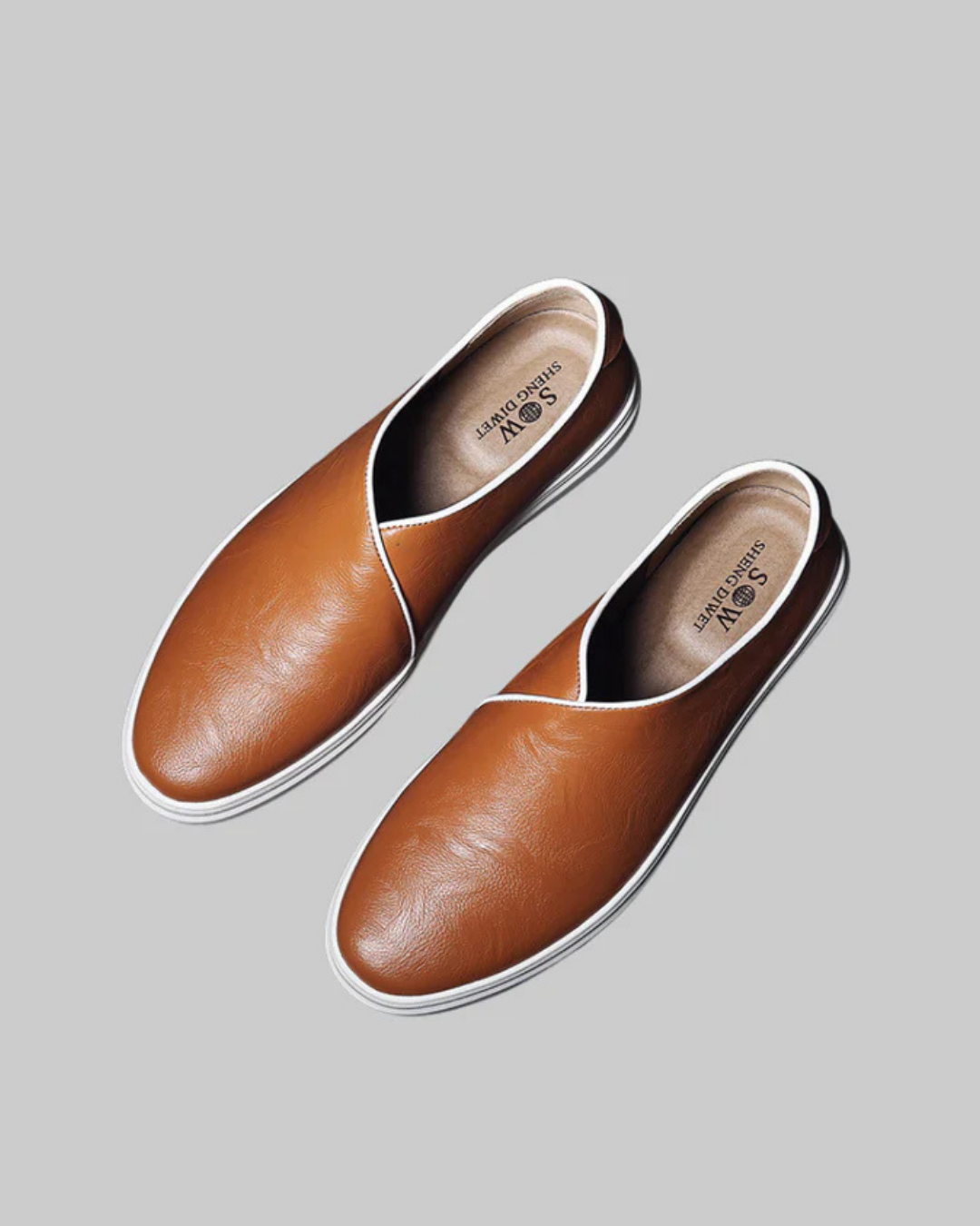 Pair of brown leather shoes on a gray background