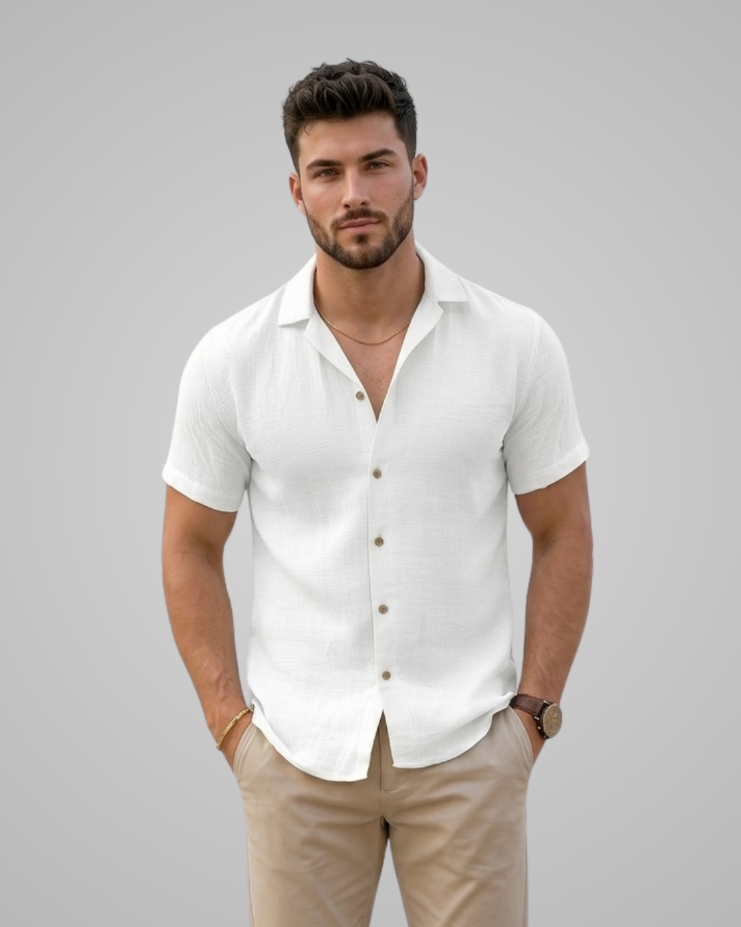 Man wearing a white short-sleeve shirt and beige pants against a gray background