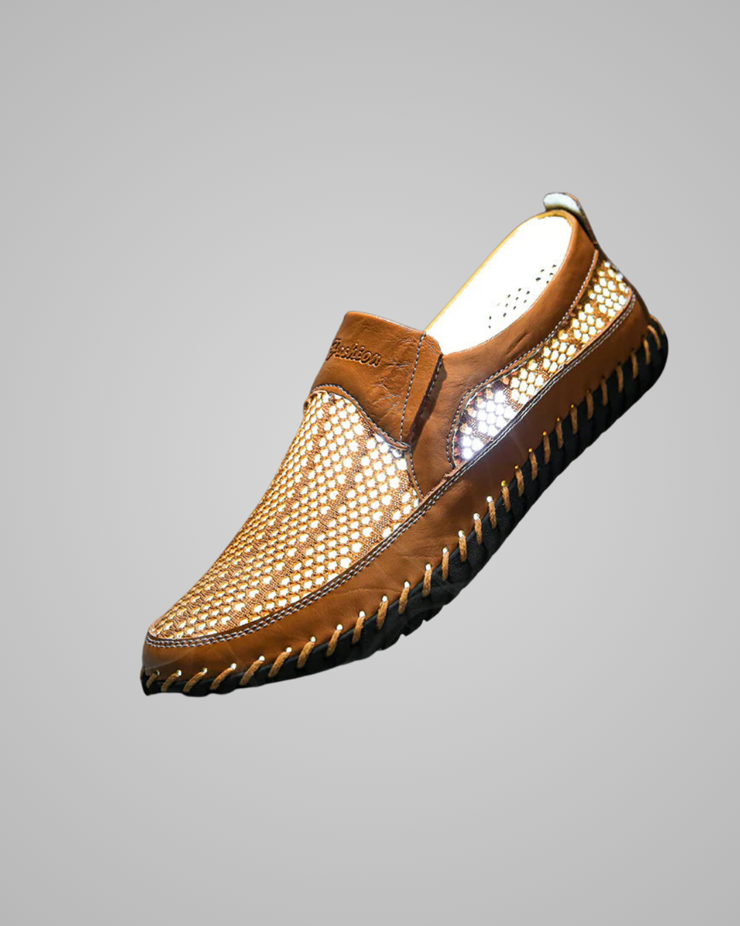 Brown leather slip-on shoe with rhinestone embellishments on a gray background