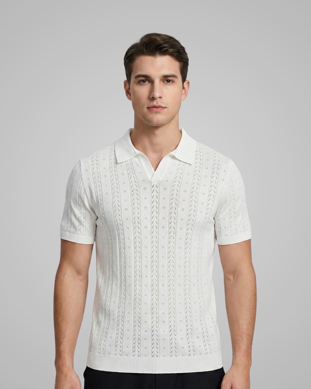 Man wearing a white textured polo shirt against a gray background