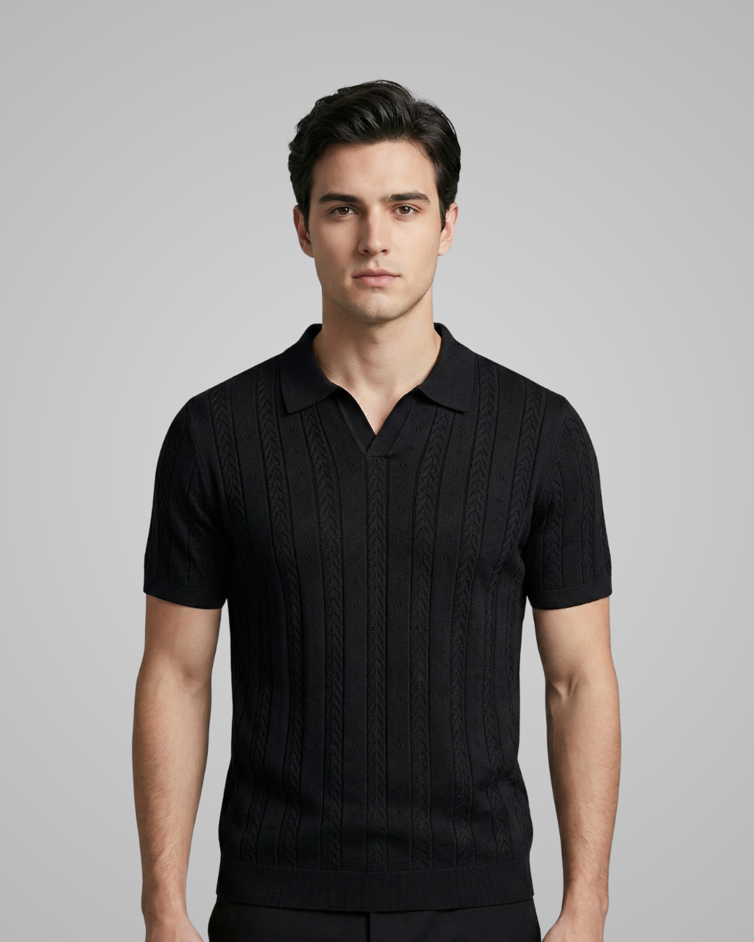 Man wearing a black ribbed knit polo shirt against a gray background