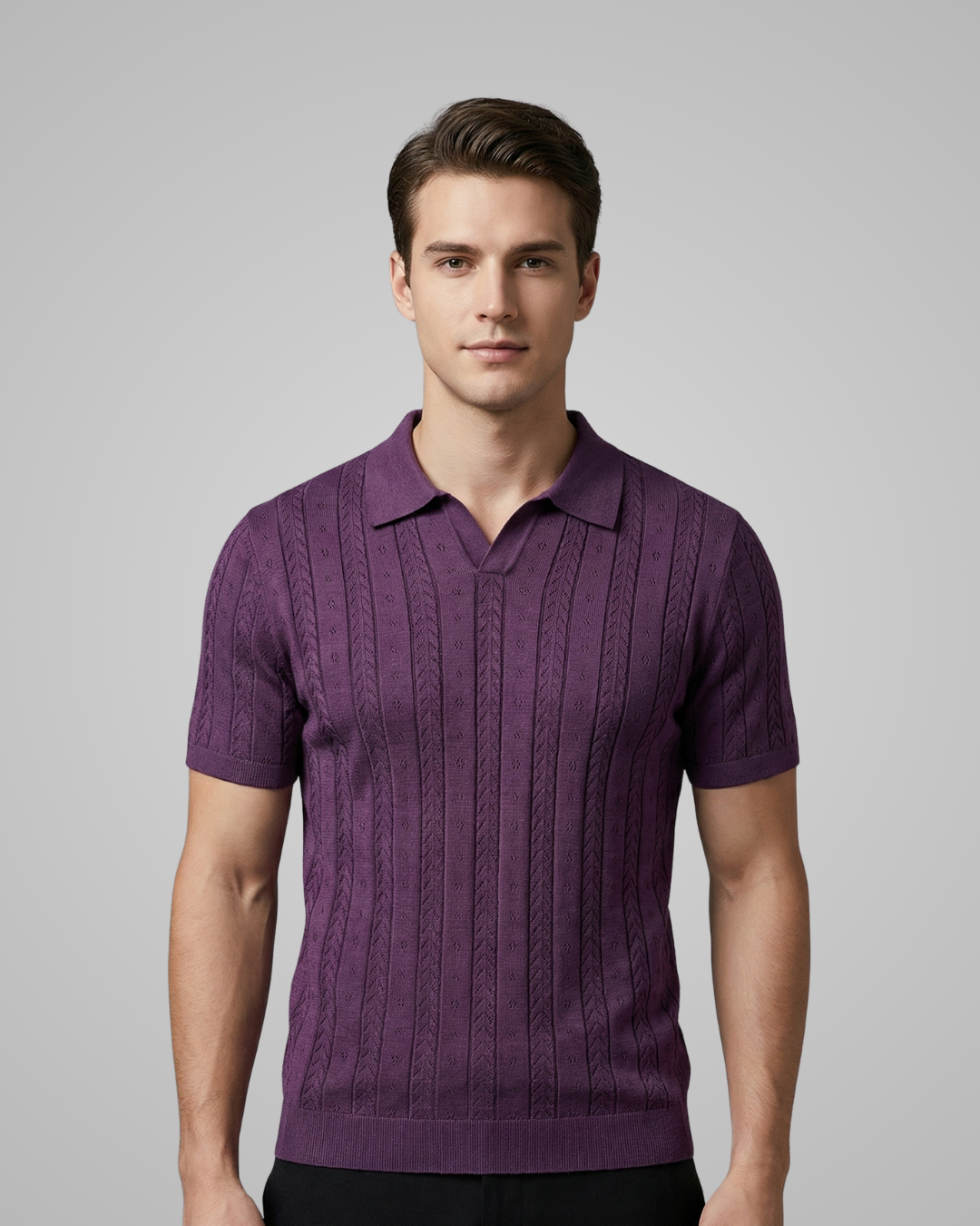 Man wearing a purple knitted polo shirt against a gray background