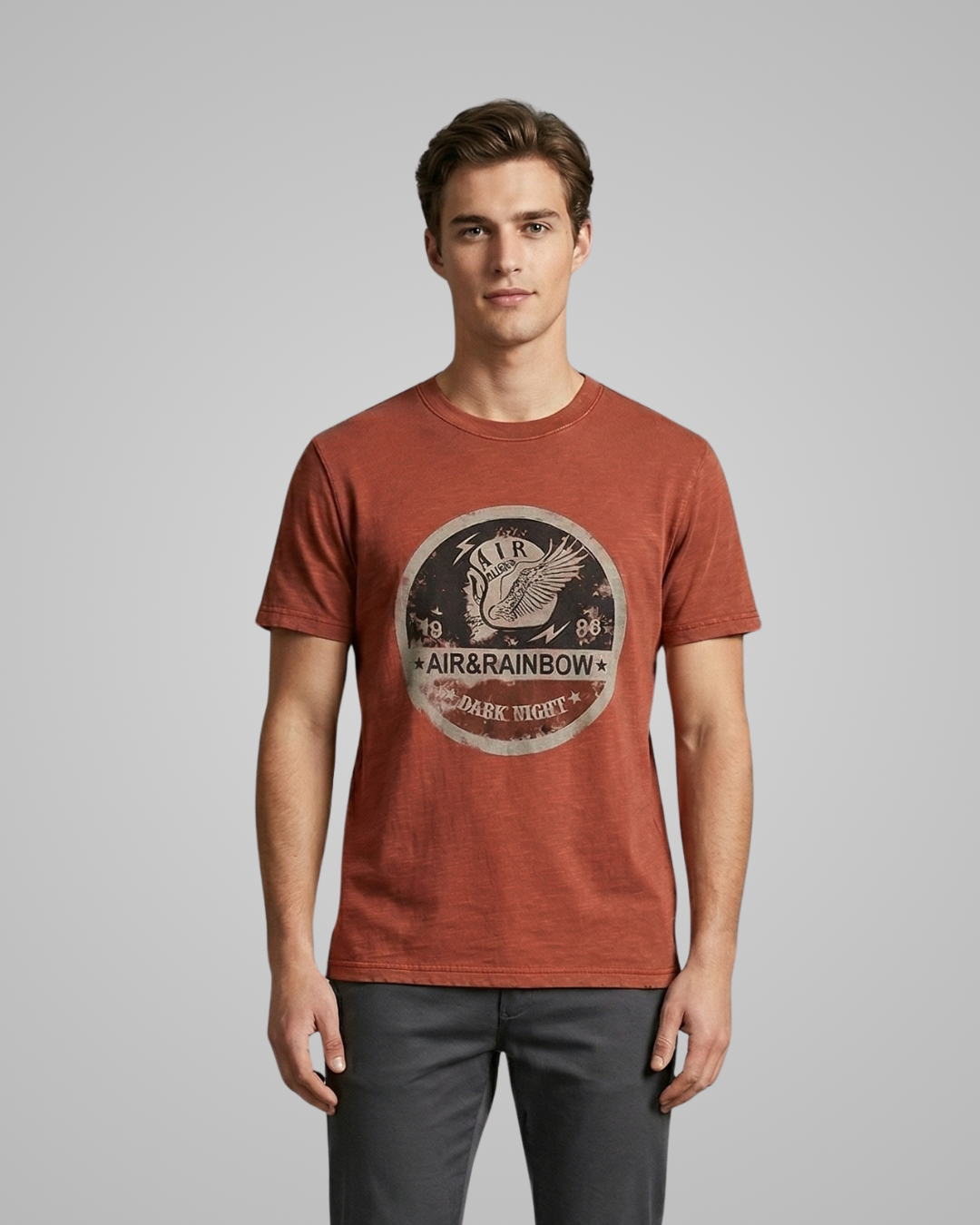 Man wearing a red t-shirt with a logo on a gray background