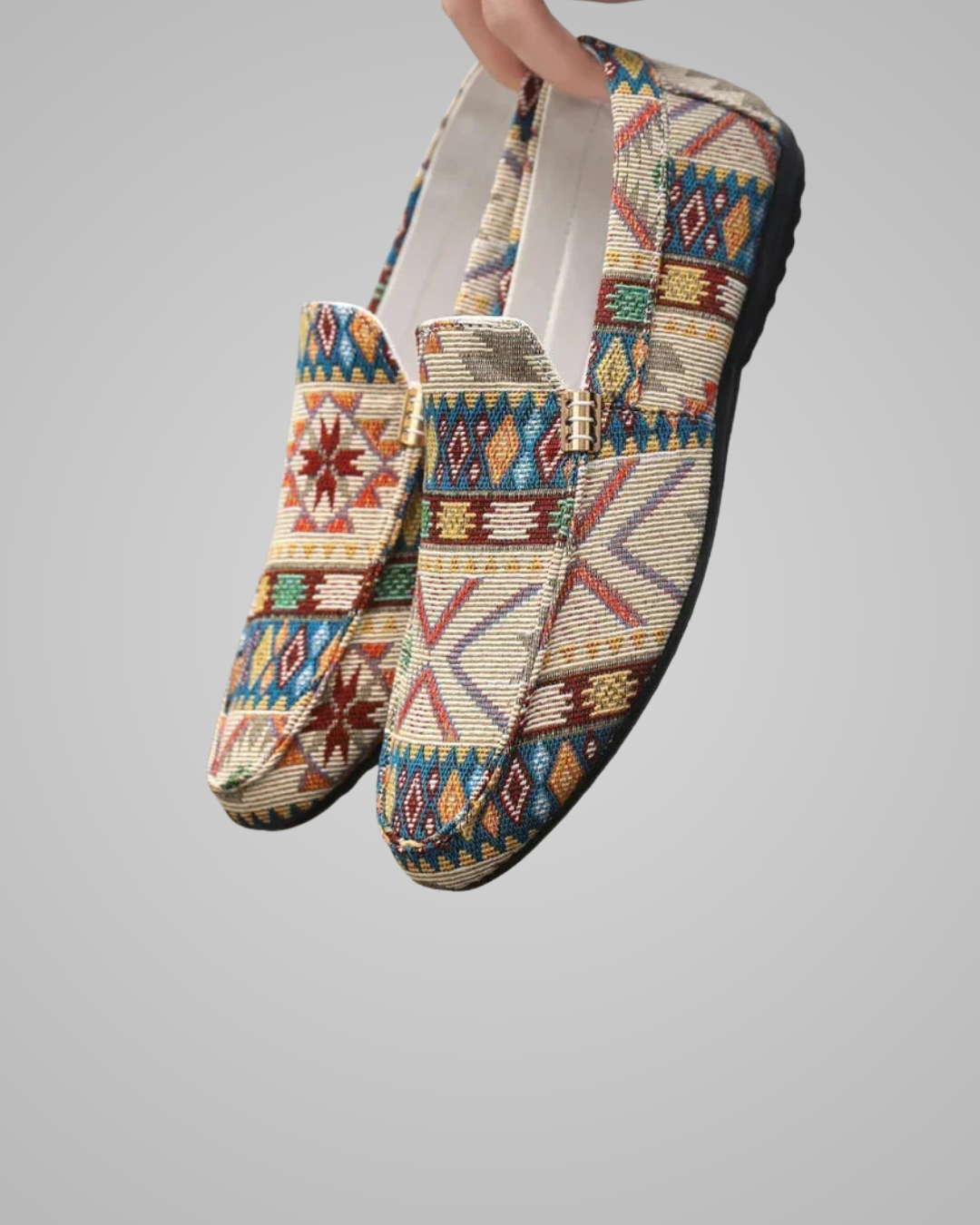 Colorful beaded shoes with geometric patterns on a gray background