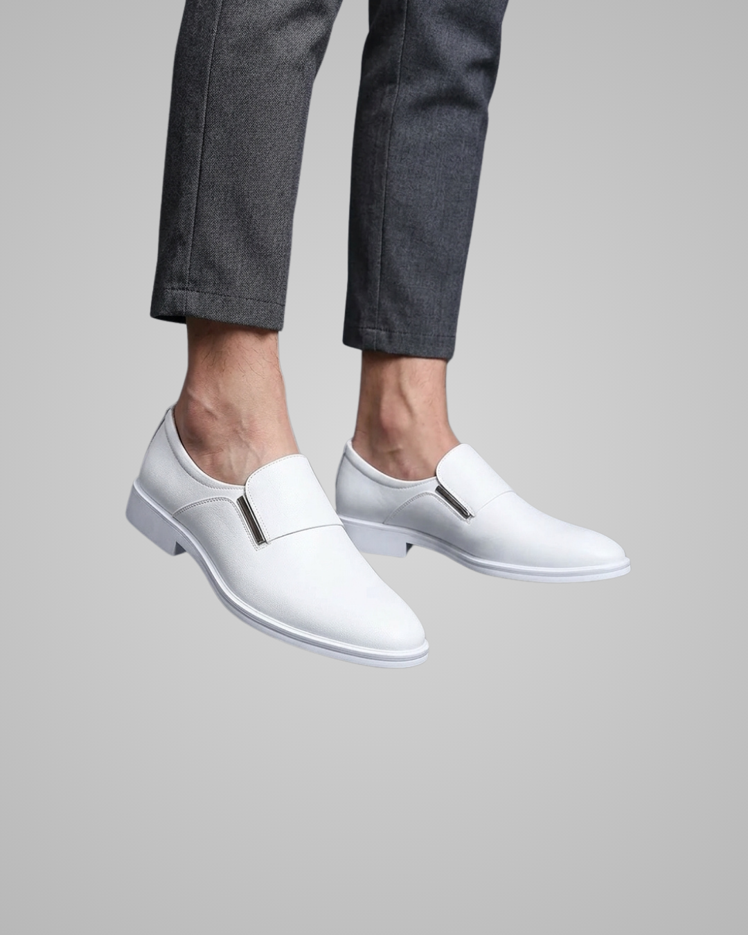 White loafers worn with gray pants on a light gray background