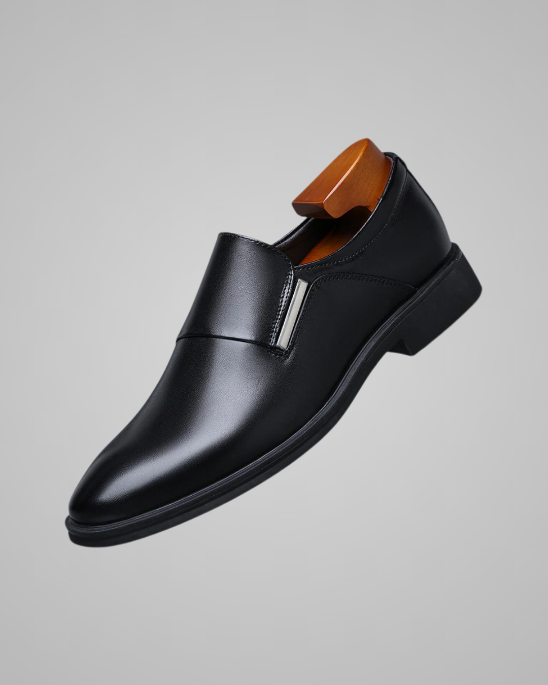 Black dress shoe on a gray background