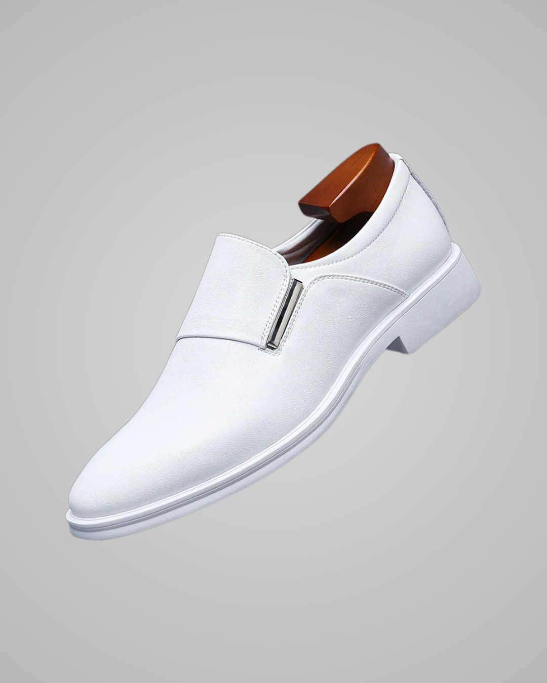 White leather dress shoe on a gray background
