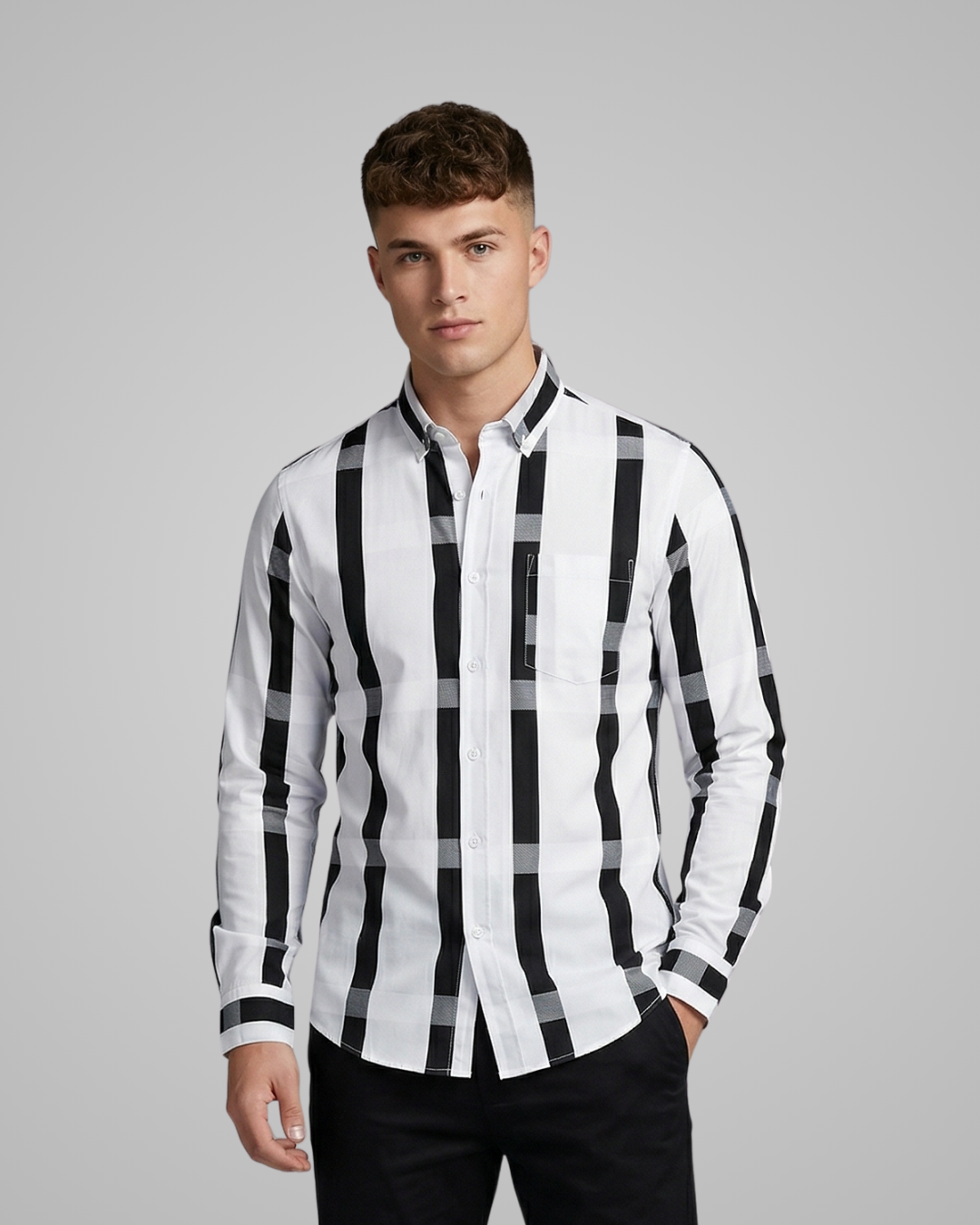 Man wearing a black and white checkered shirt against a gray background