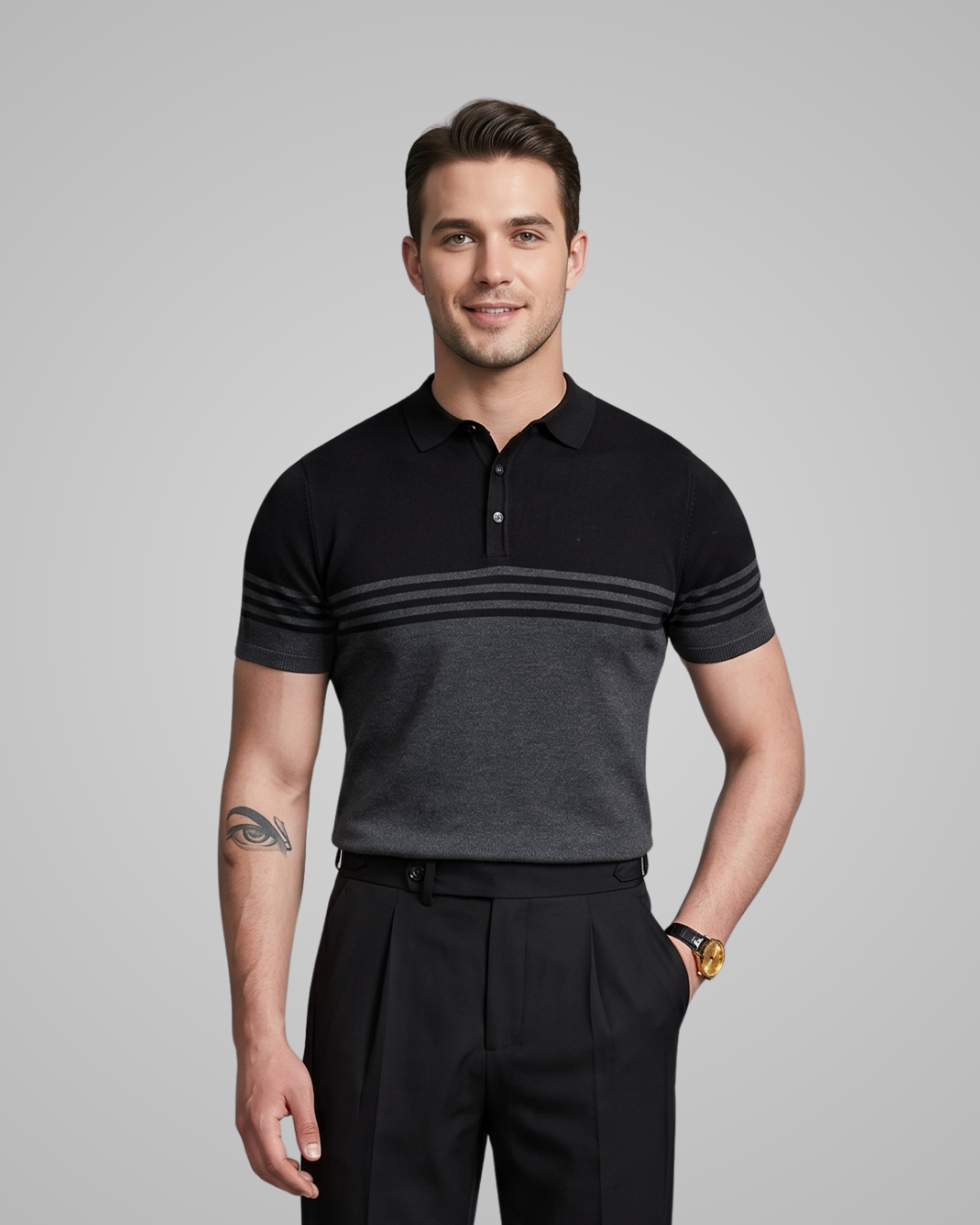 Man wearing a black and gray striped polo shirt against a gray background