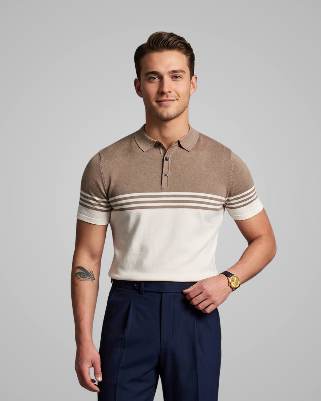 Man wearing a brown and white striped polo shirt with navy pants on a gray background
