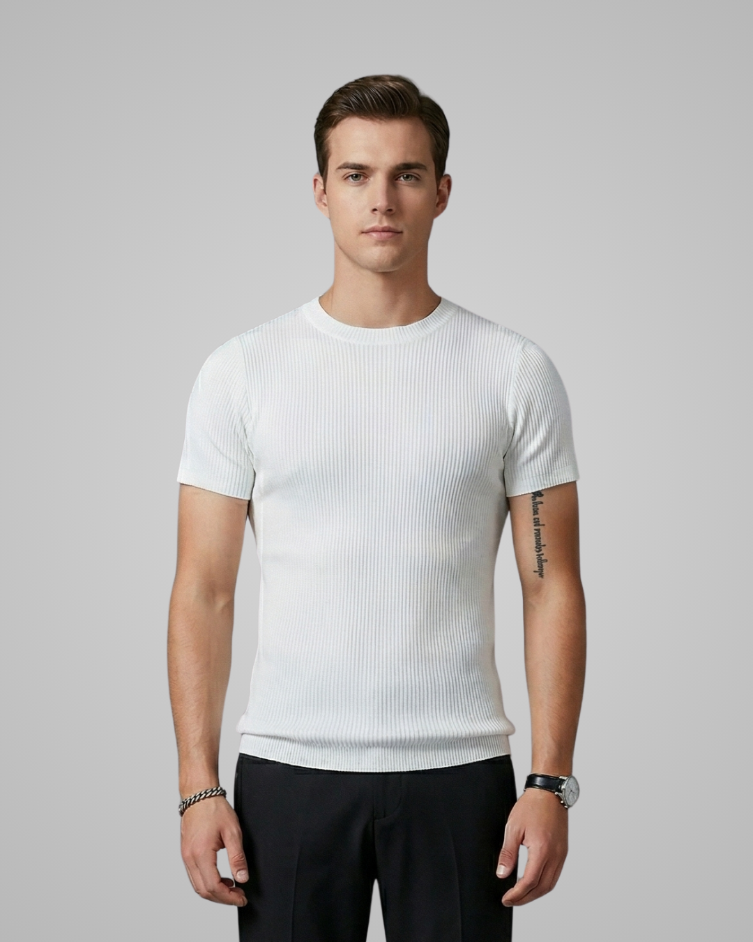 Man wearing a white ribbed t-shirt and black pants on a gray background