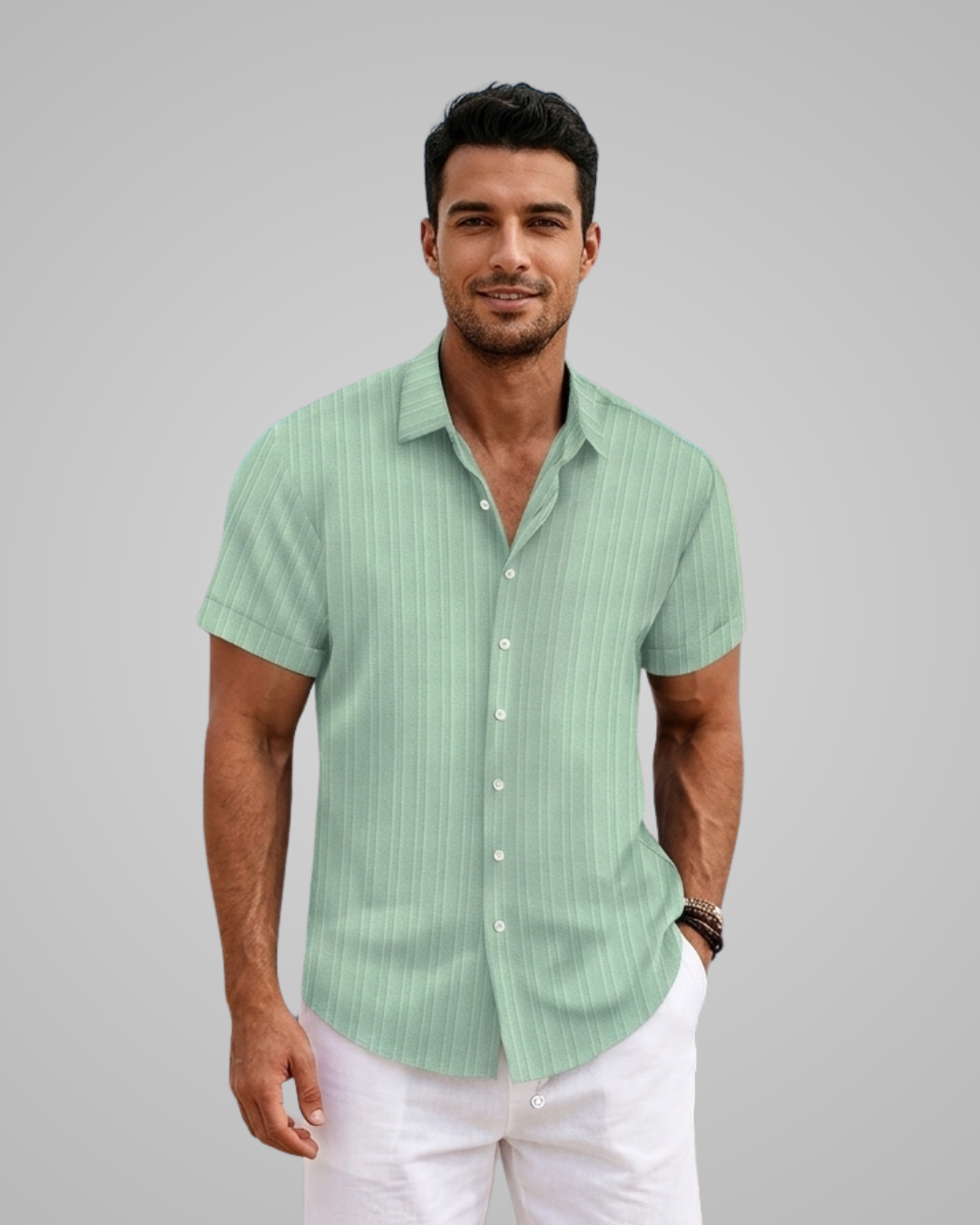 Man wearing a green striped shirt and white pants against a gray background