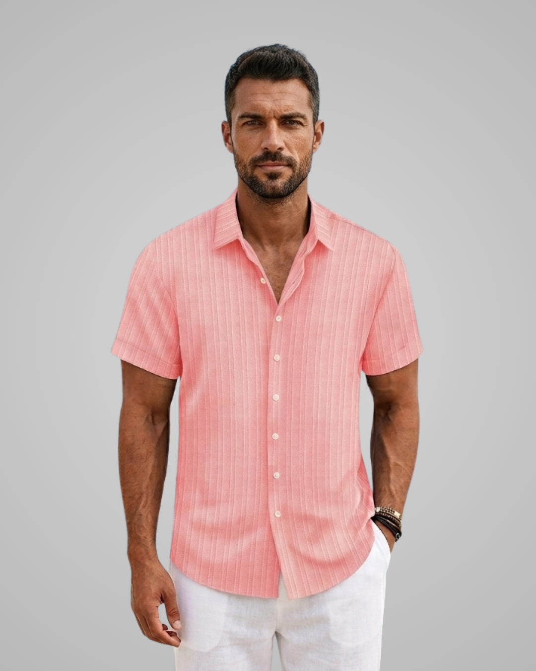 Man wearing a pink striped shirt against a gray background