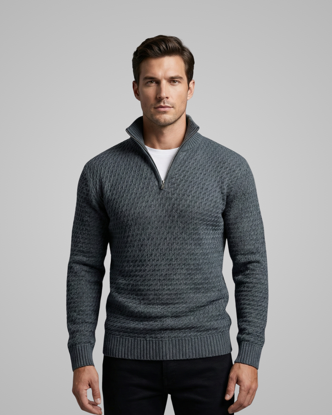 Man wearing a gray patterned sweater on a gray background