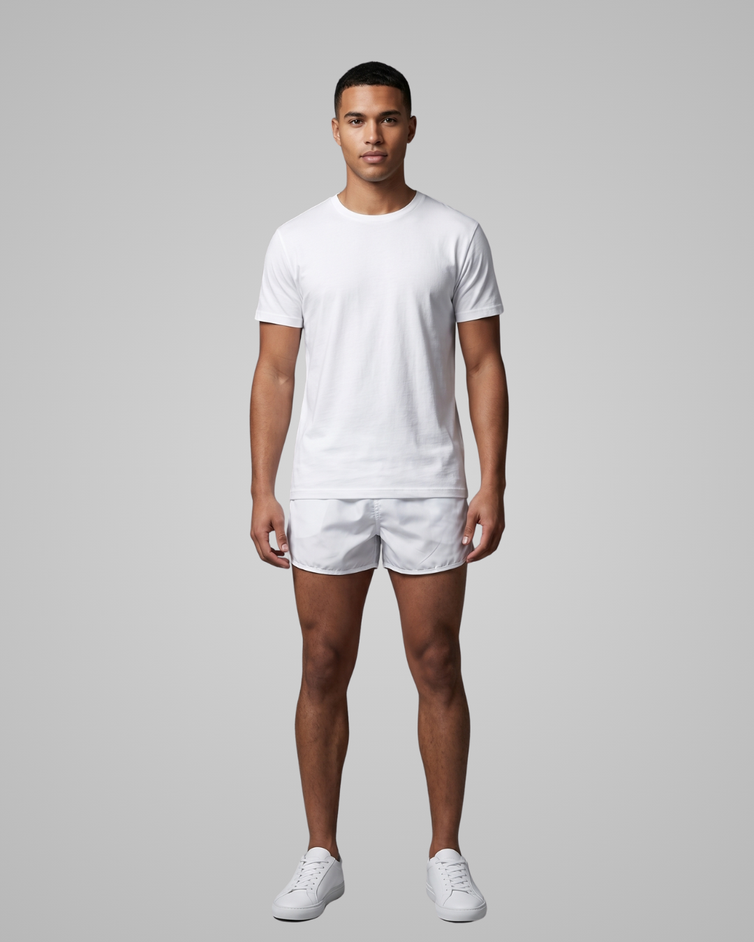 Man wearing a white t-shirt and shorts set on a gray background