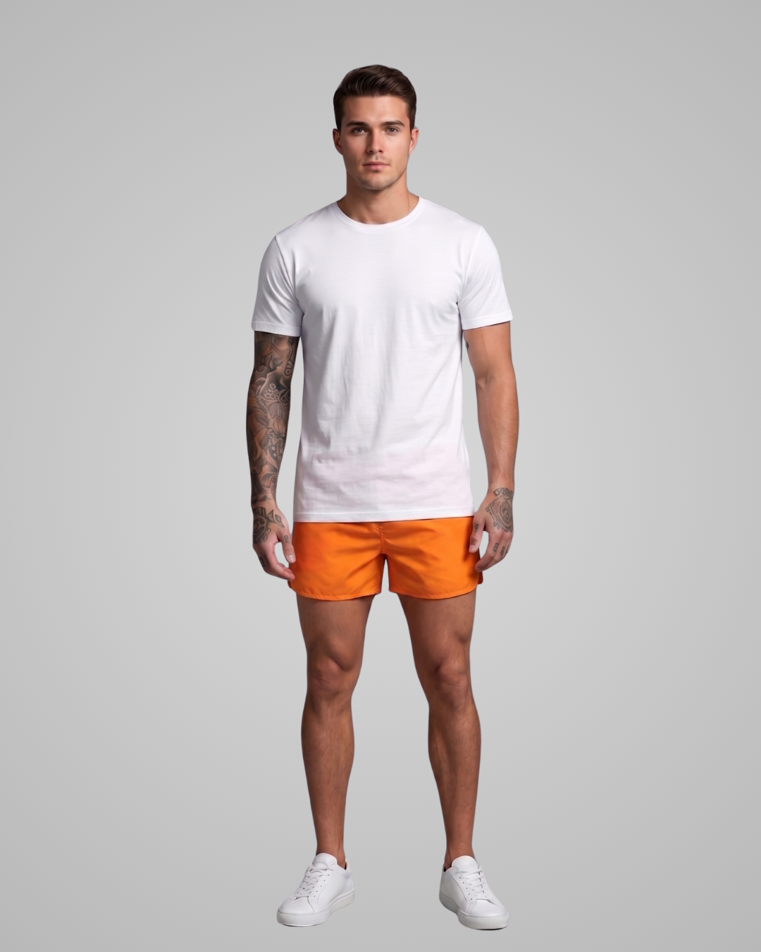 Man wearing a white t-shirt and orange shorts on a gray background