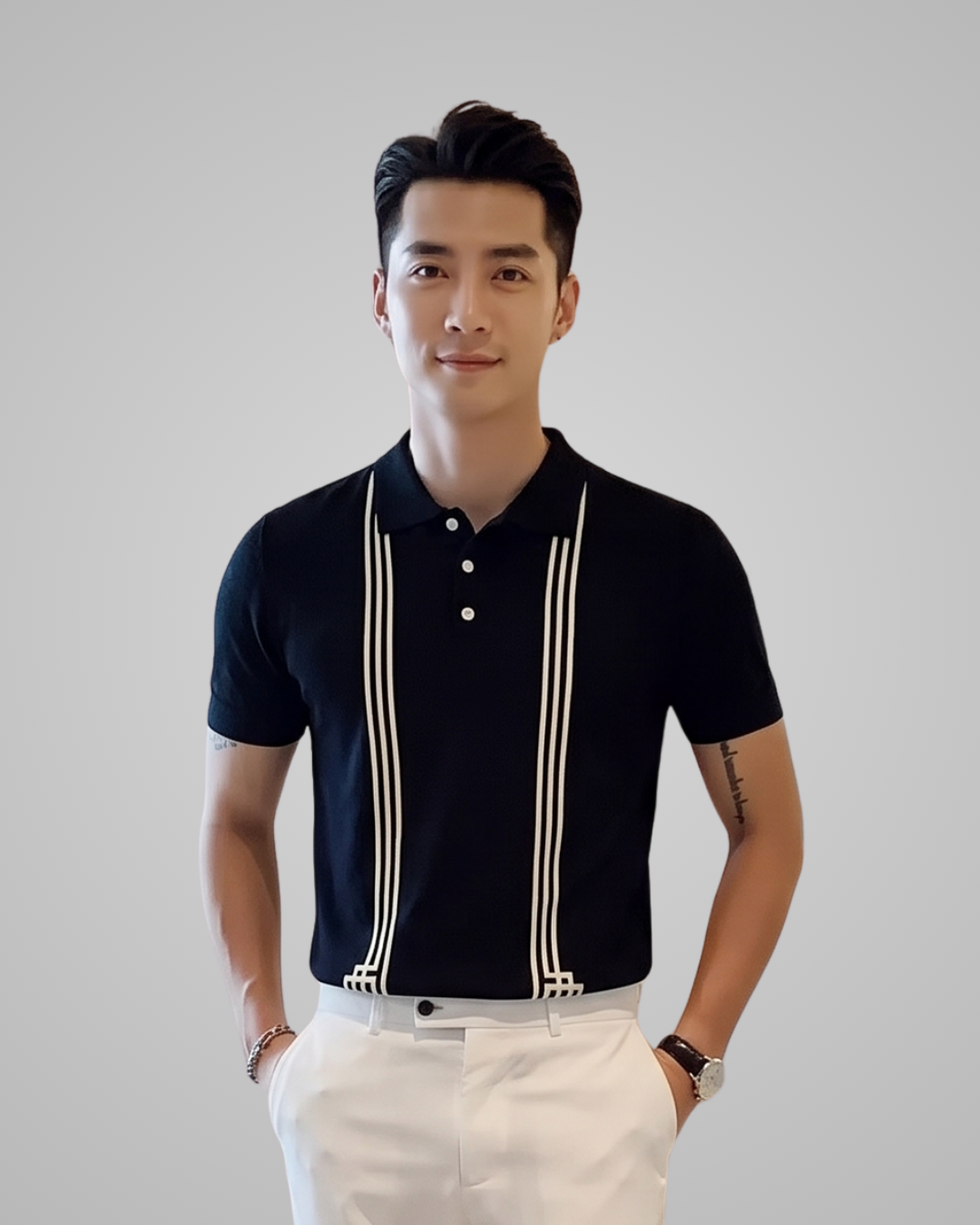 Man wearing a black polo shirt with white suspenders against a plain background