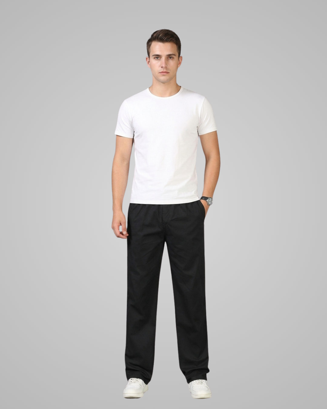 Man wearing a white t-shirt and black pants on a gray background
