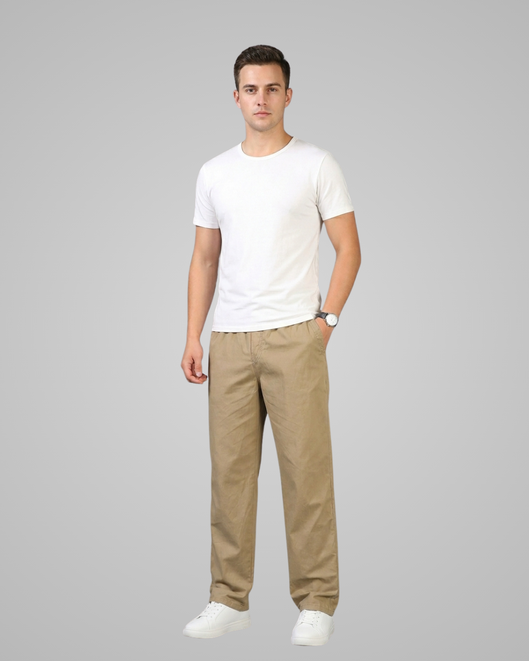 Man wearing a white t-shirt and beige pants on a gray background