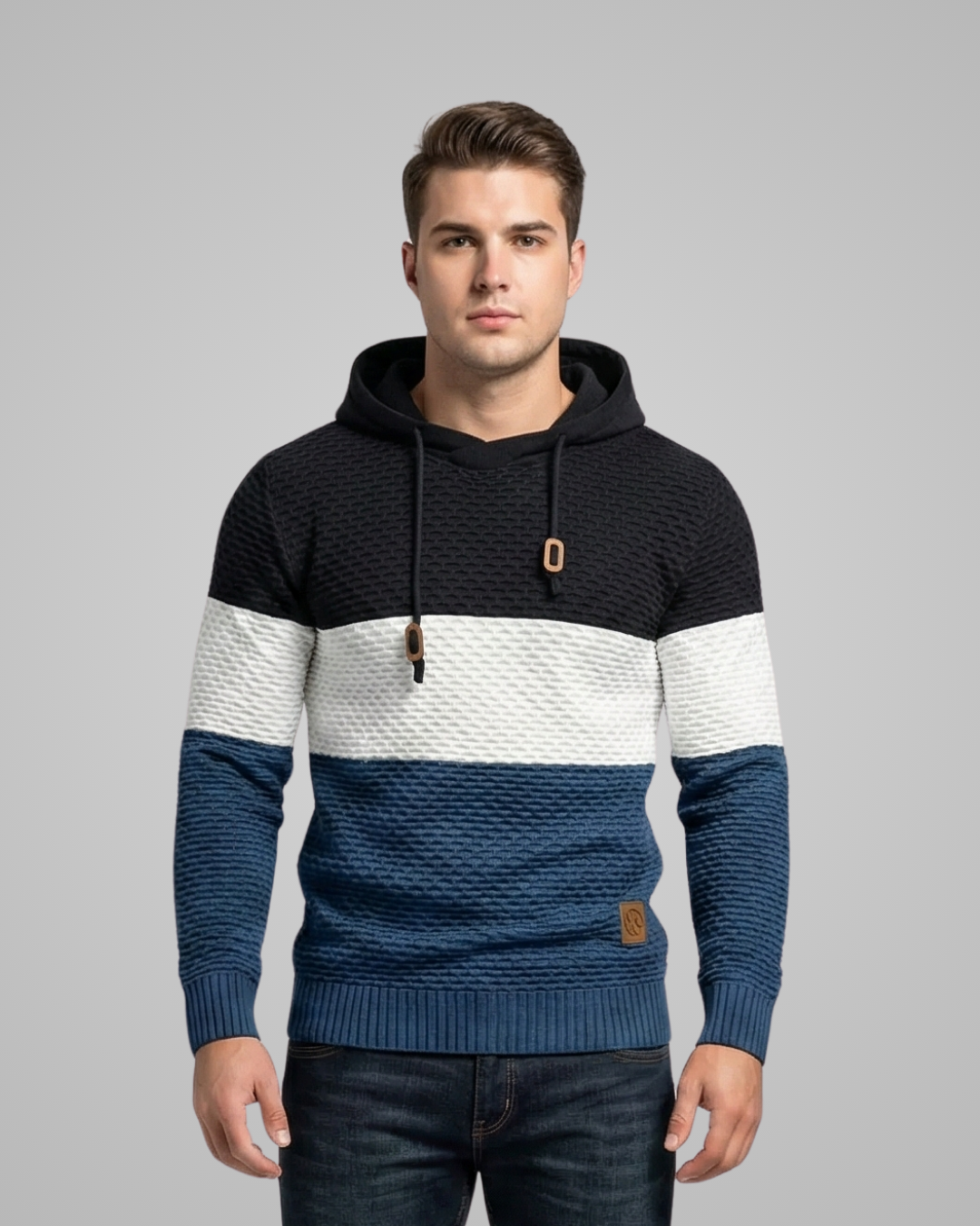 Man wearing a black, blue, and white striped hoodie on a gray background