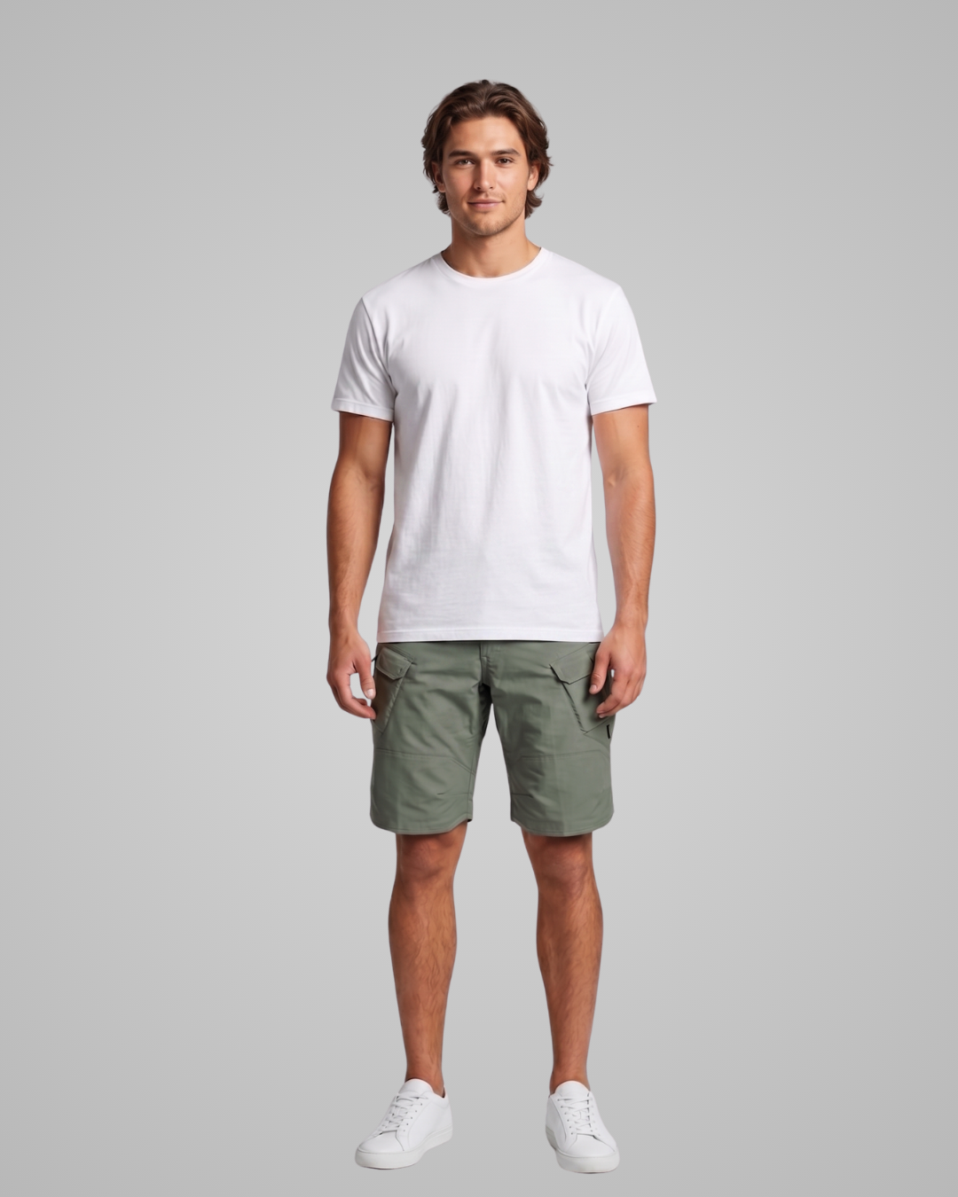 Man wearing a white t-shirt and green shorts on a gray background