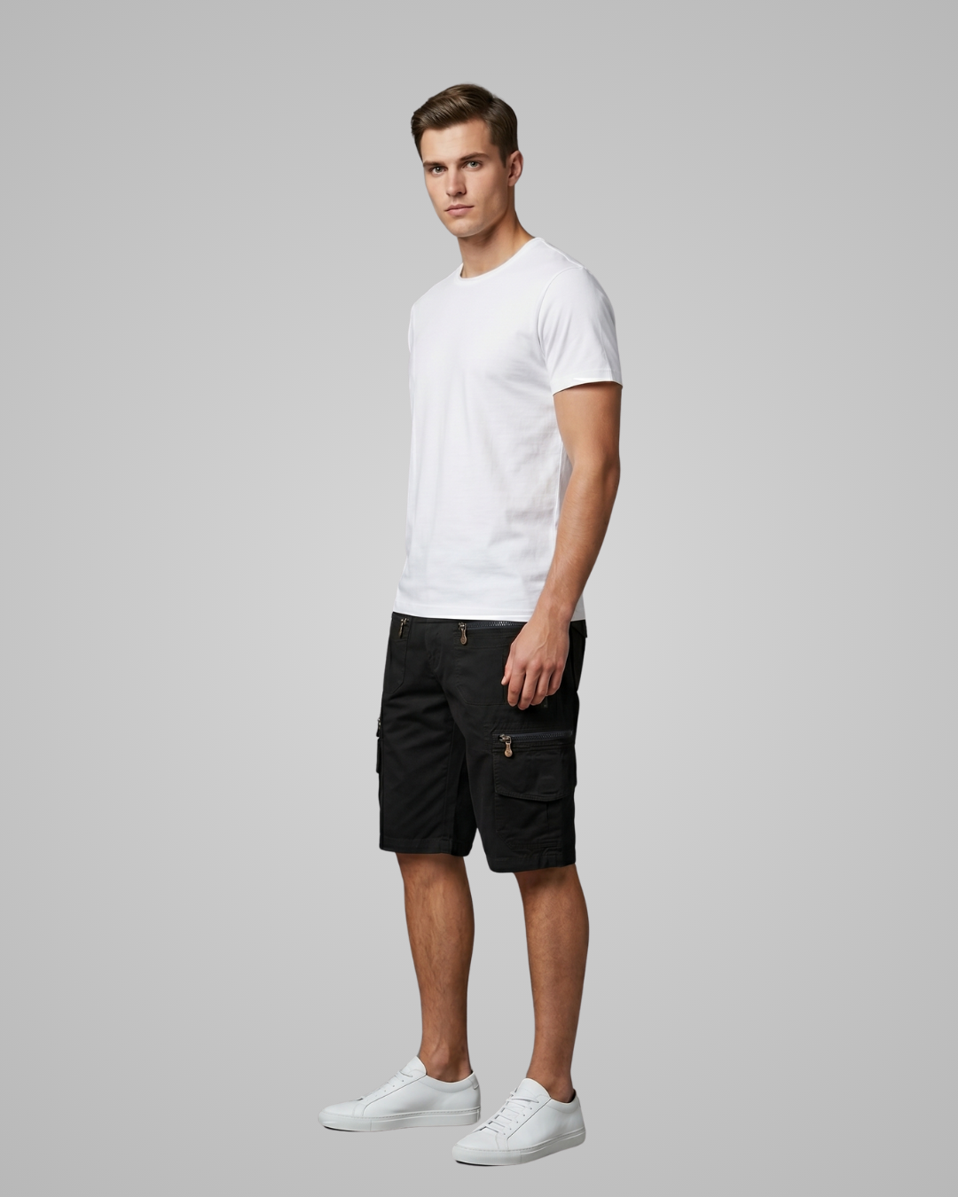Man wearing a white t-shirt and black shorts on a gray background