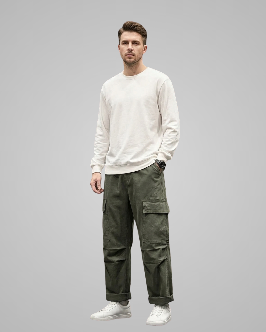 Man wearing a white sweater and green cargo pants on a gray background