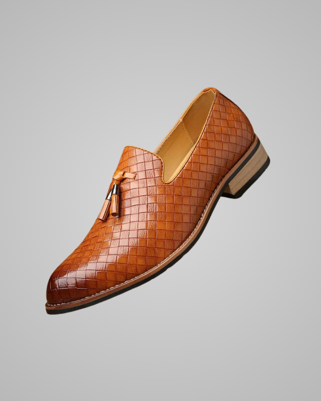 Brown woven loafer with tassel on a gray background