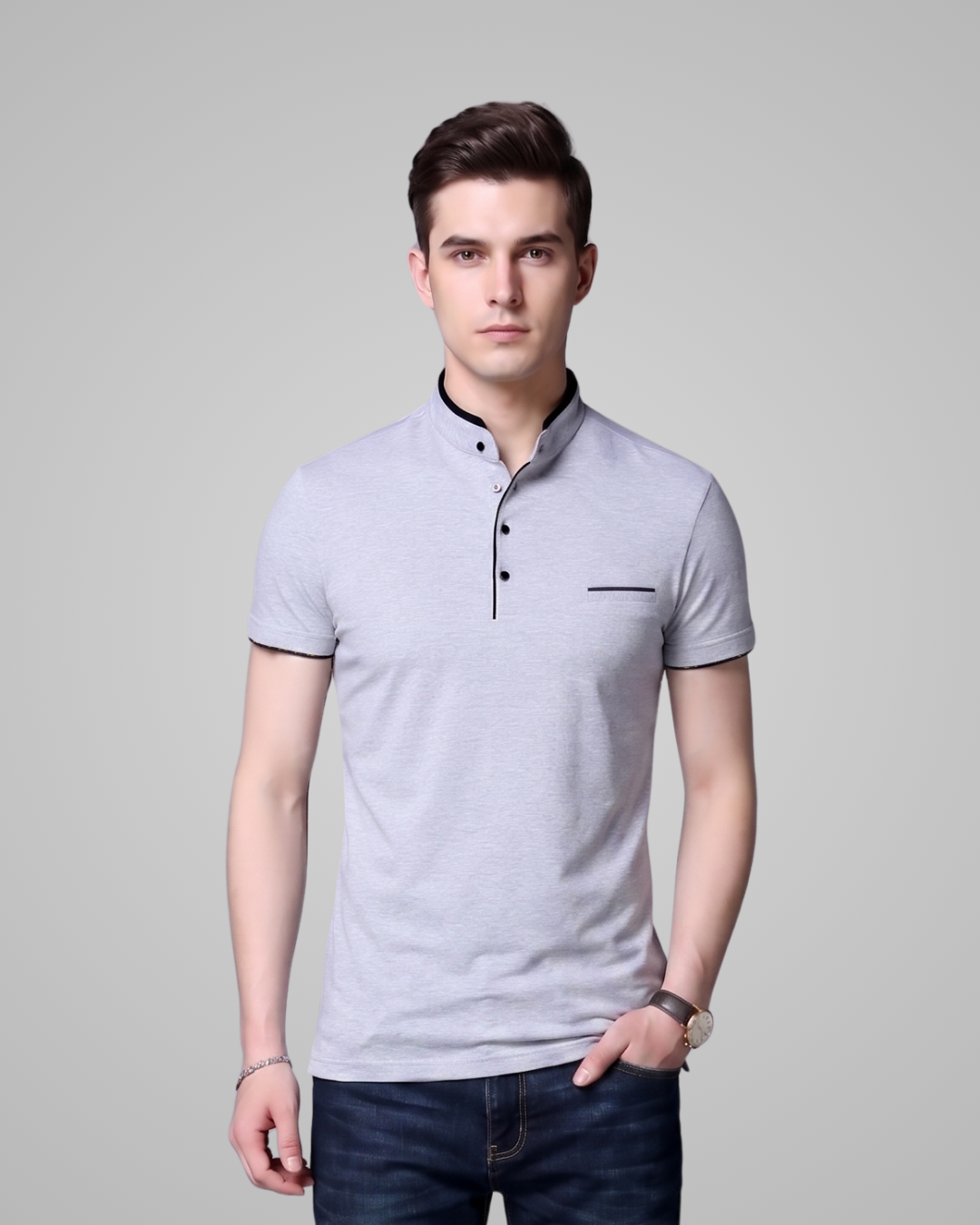 Man wearing a light gray polo shirt with black trim on a plain background