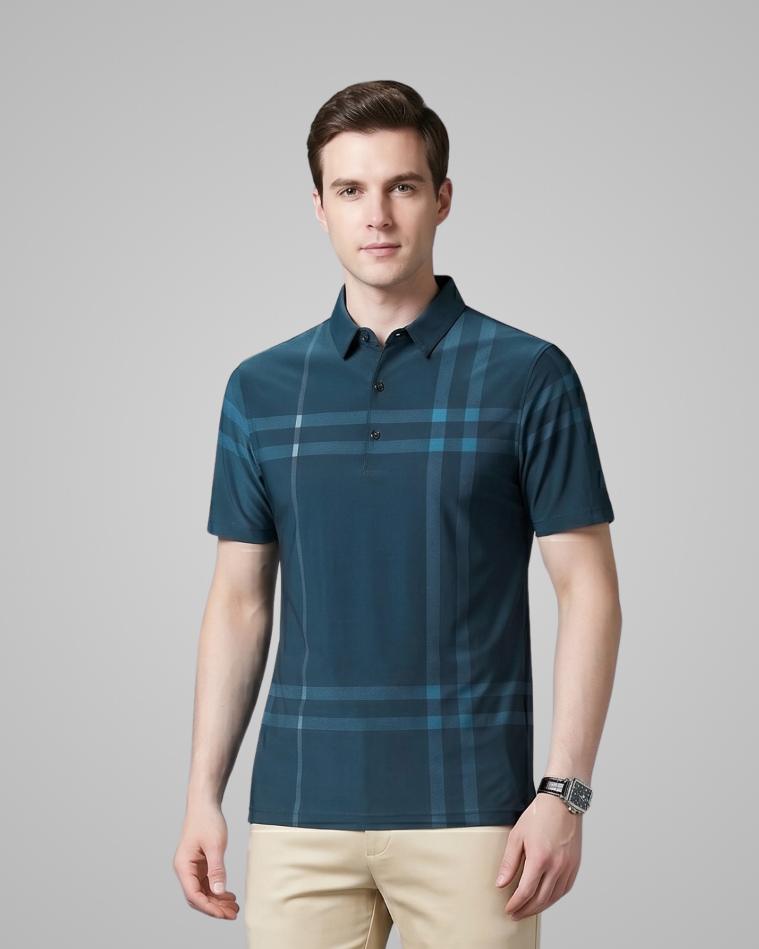 Man wearing a blue plaid shirt against a gray background