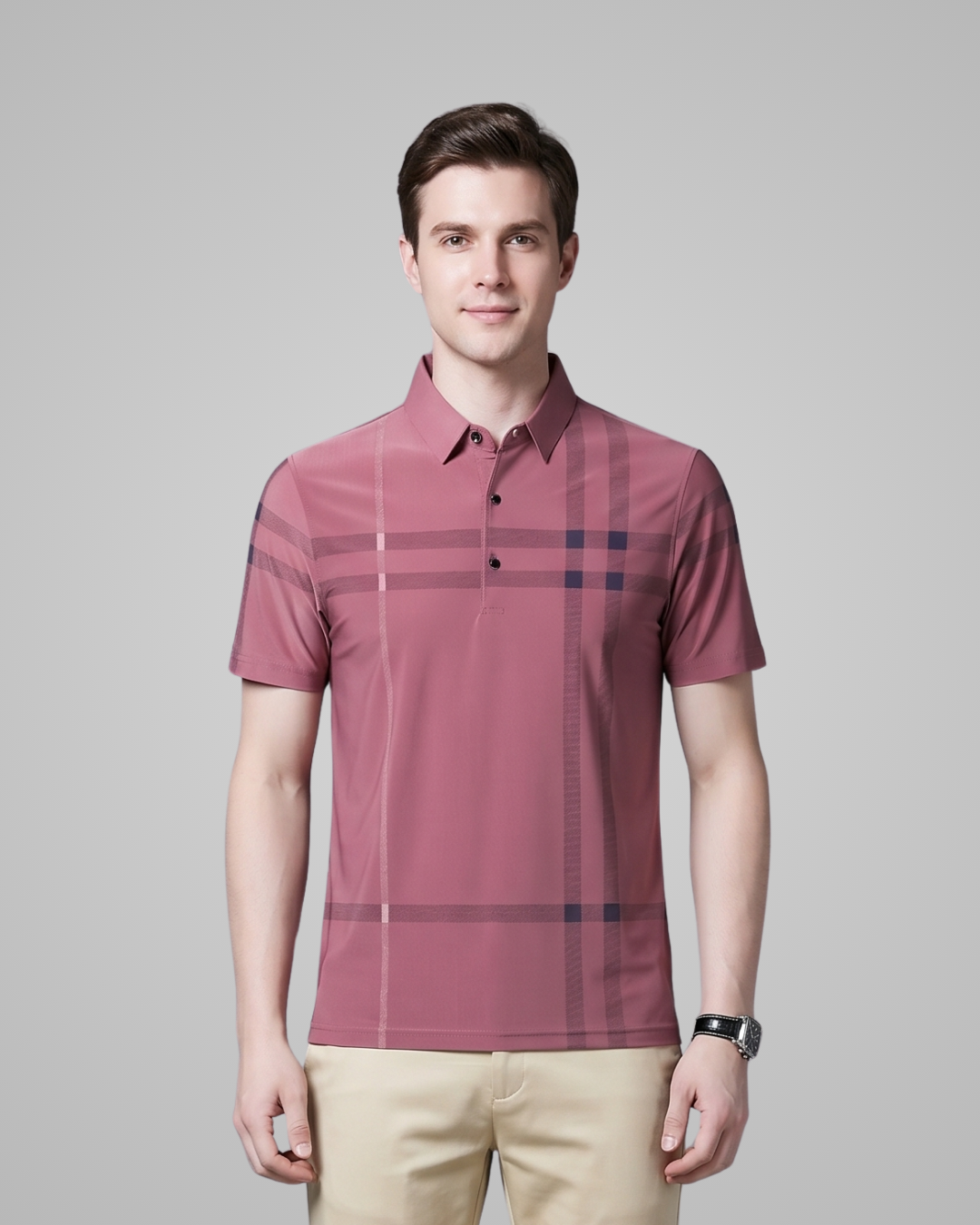 Man wearing a maroon checkered polo shirt against a gray background