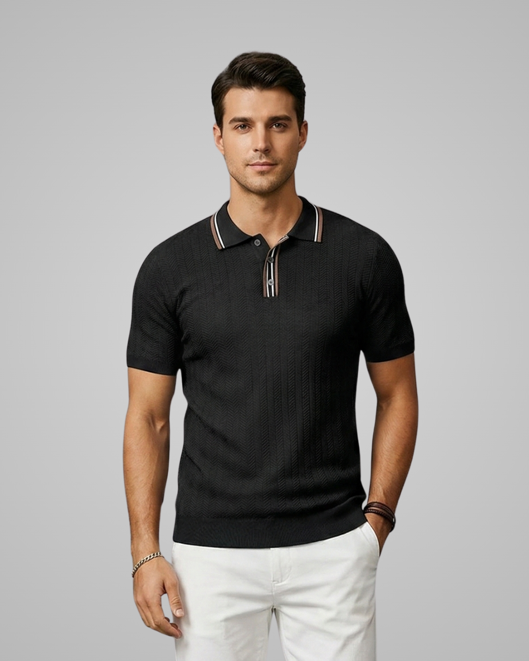 Man wearing a black polo shirt with white pants on a gray background