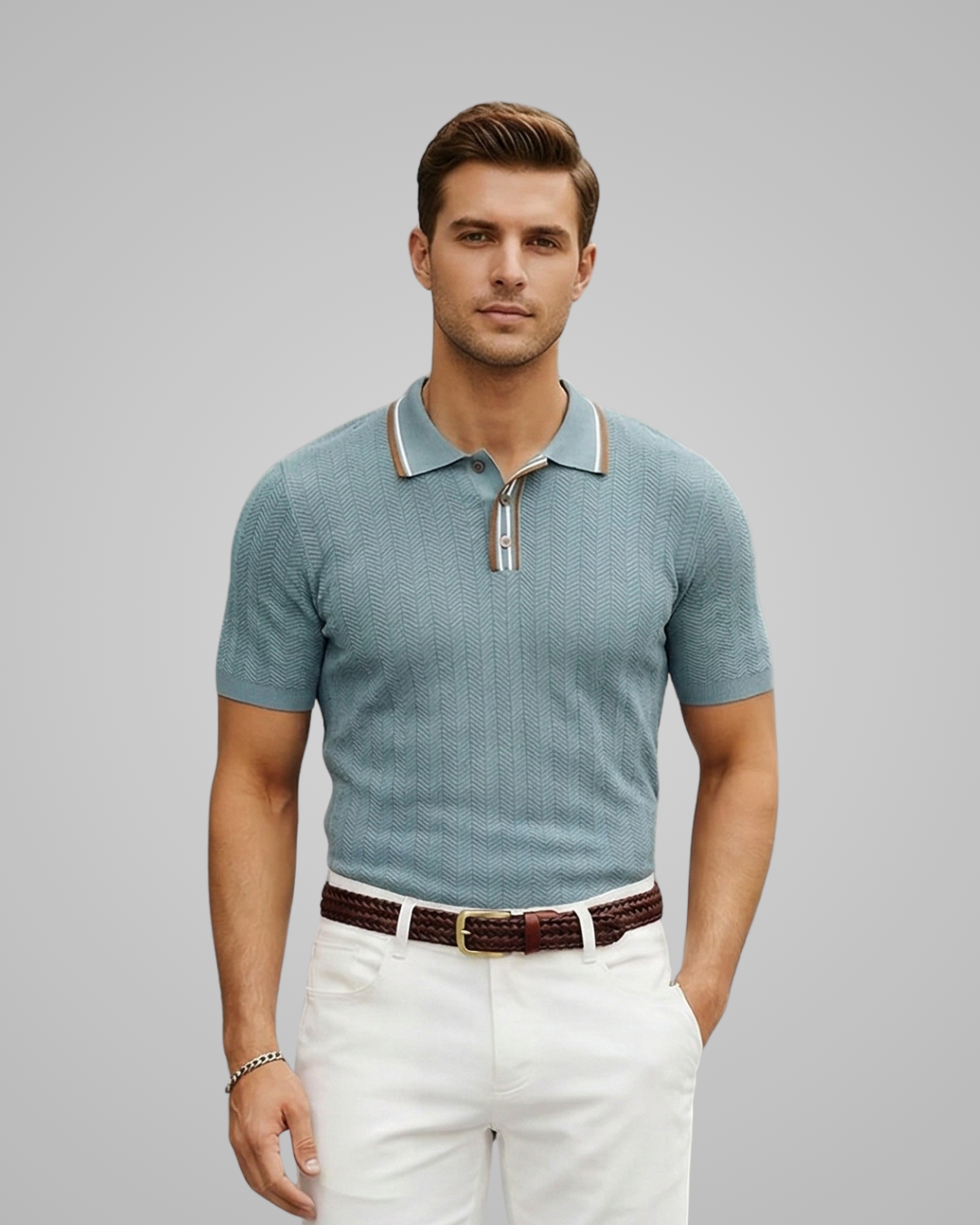 Man wearing a light blue patterned polo shirt and white pants on a gray background