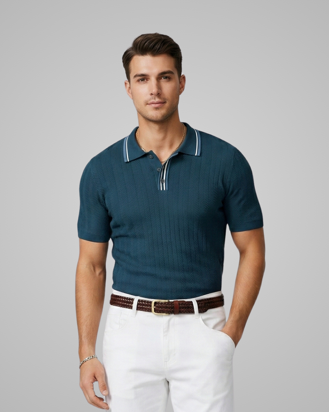 Man wearing a teal polo shirt and white pants against a gray background