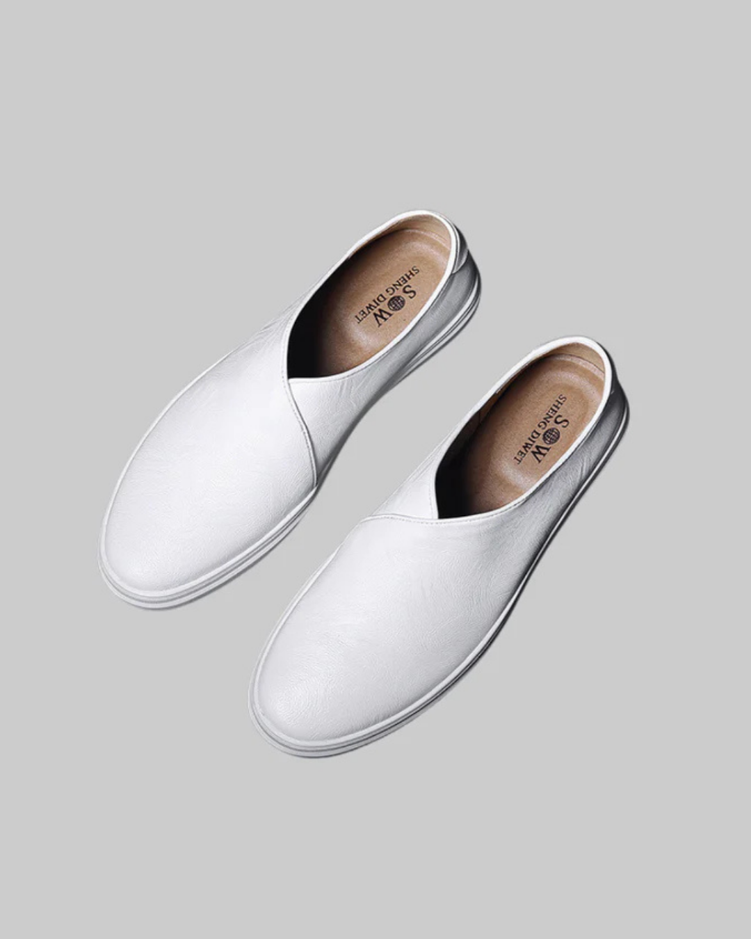 White slip-on shoes on a gray background