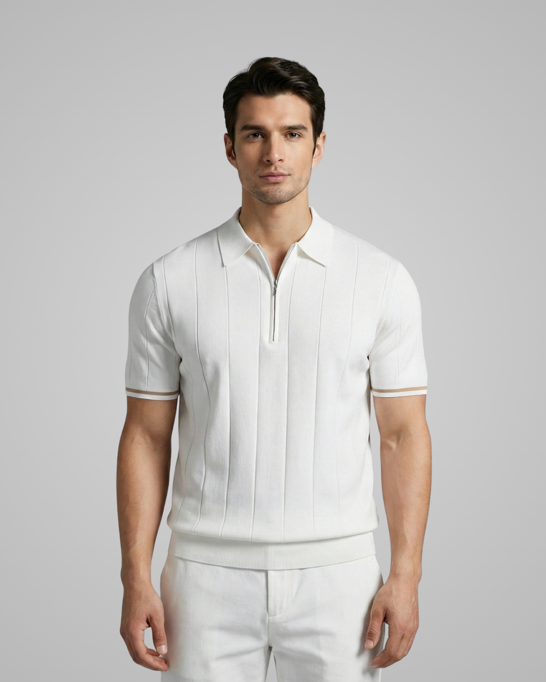 Man wearing a white short-sleeve shirt and pants against a gray background