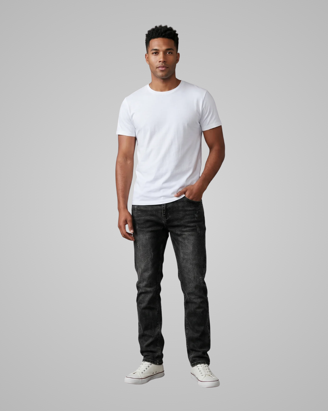 Man wearing a white t-shirt and black jeans on a gray background