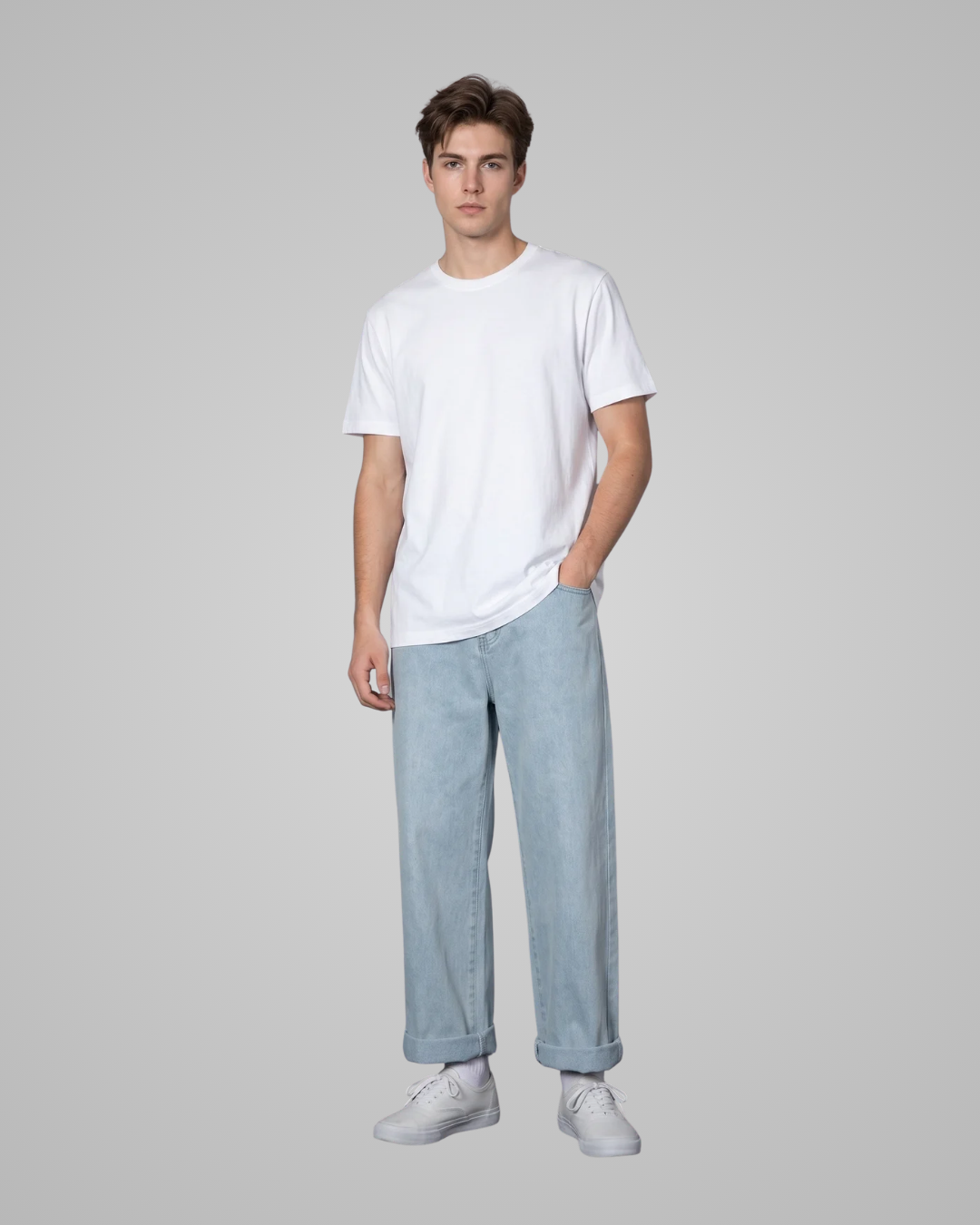 Person wearing a white t-shirt and light blue jeans on a gray background