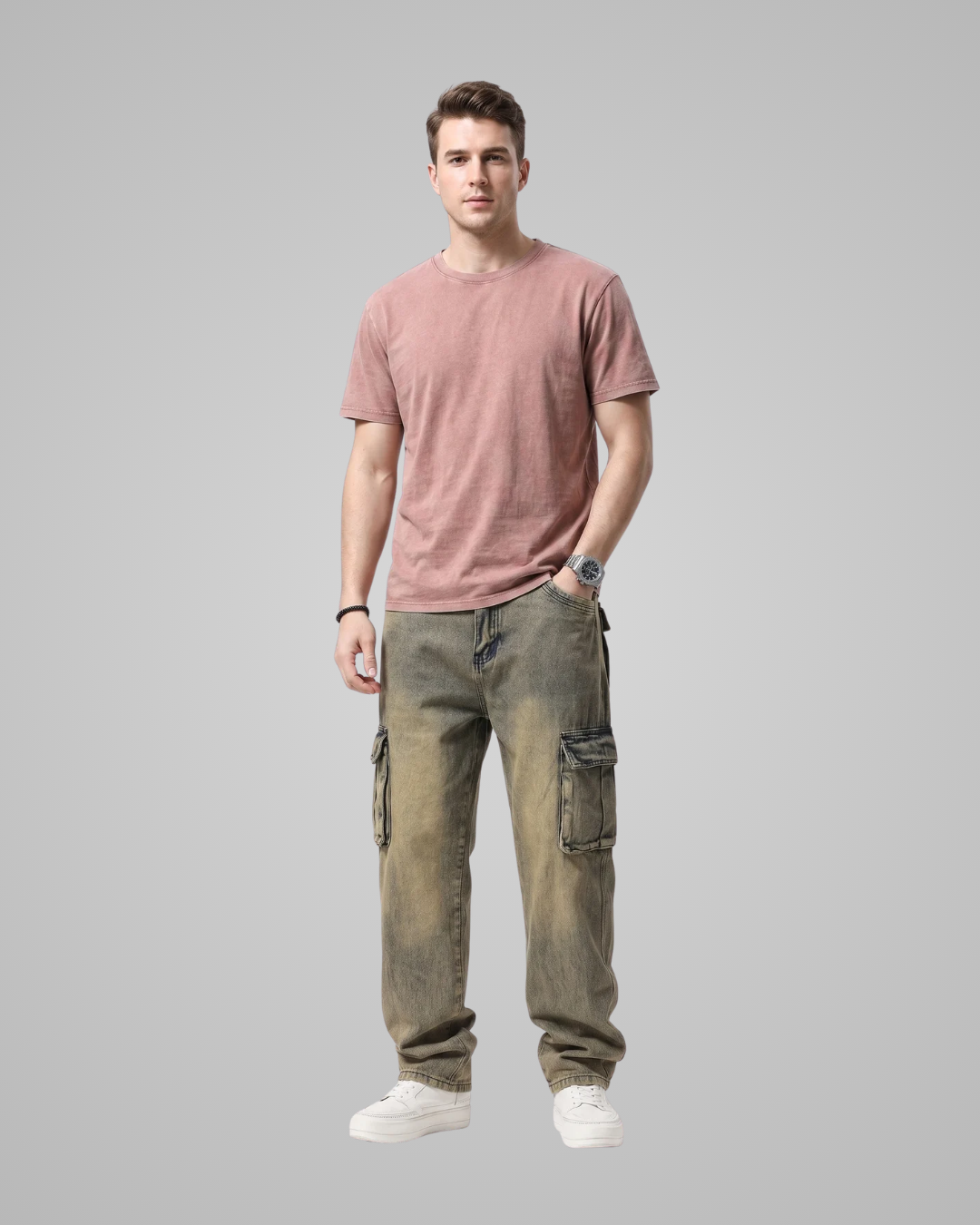 Man wearing a pink t-shirt and green cargo pants on a gray background