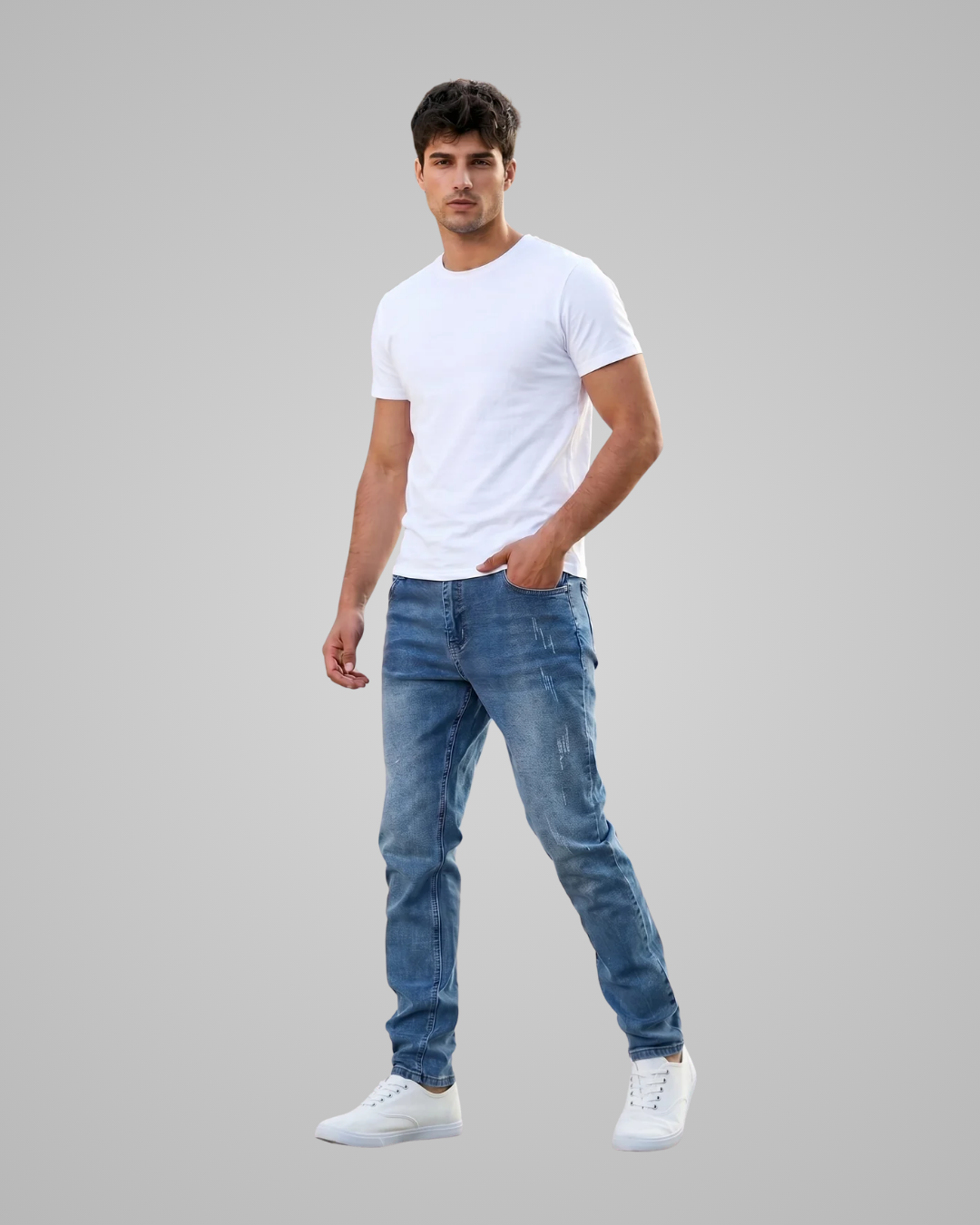 Man wearing a white t-shirt and blue jeans on a gray background